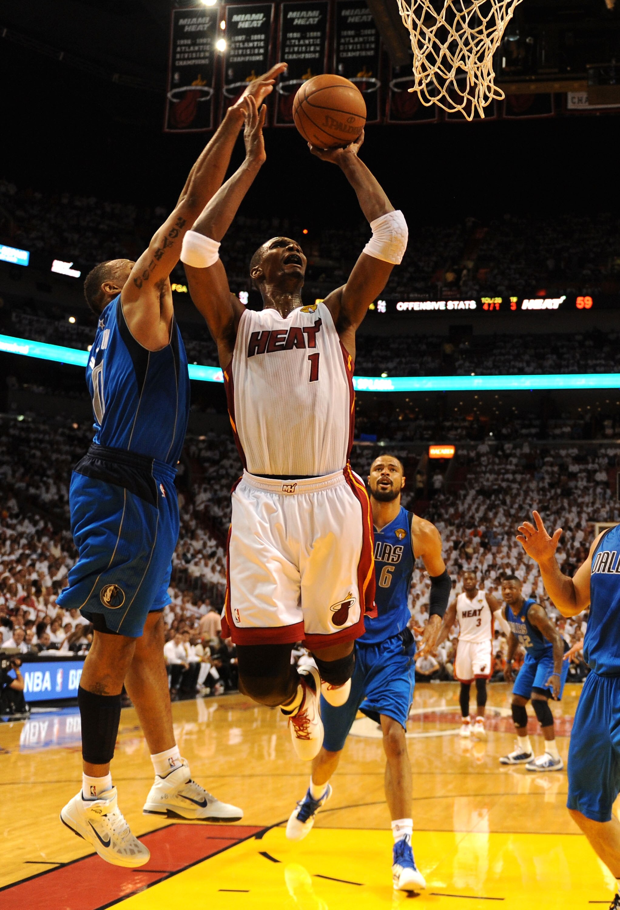 MIAMI, FL - JUNE 02:  Chris Bosh #1 of the Miami Heat attempts a shot against Shawn Marion #0 of the Dallas Mavericks in Game Two of the 2011 NBA Finals at American Airlines Arena on June 2, 2011 in Miami, Florida. The Mavericks won 95-93. NOTE TO USER: U