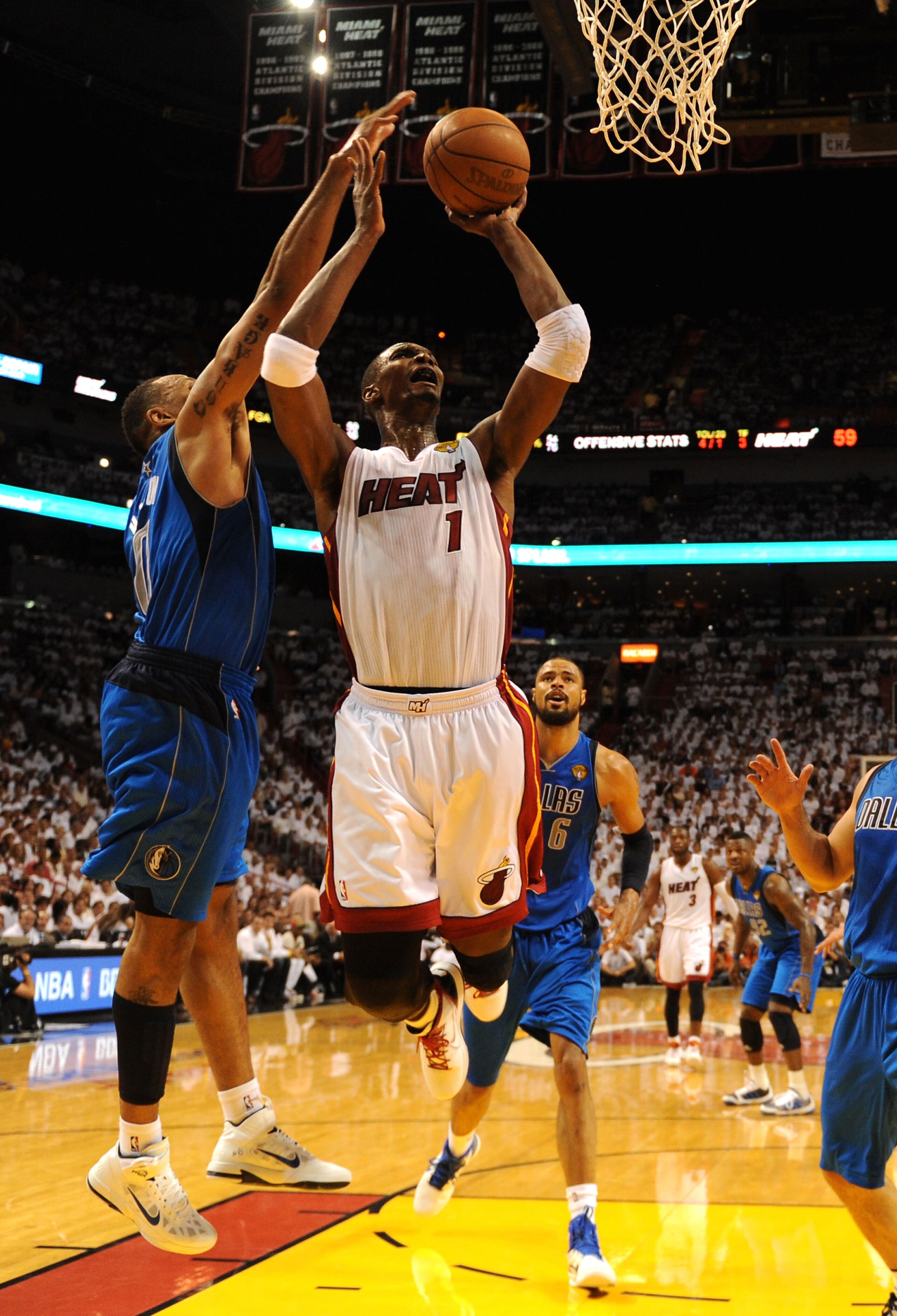 MIAMI, FL - JUNE 02:  Chris Bosh #1 of the Miami Heat attempts a shot against Shawn Marion #0 of the Dallas Mavericks in Game Two of the 2011 NBA Finals at American Airlines Arena on June 2, 2011 in Miami, Florida. The Mavericks won 95-93. NOTE TO USER: U