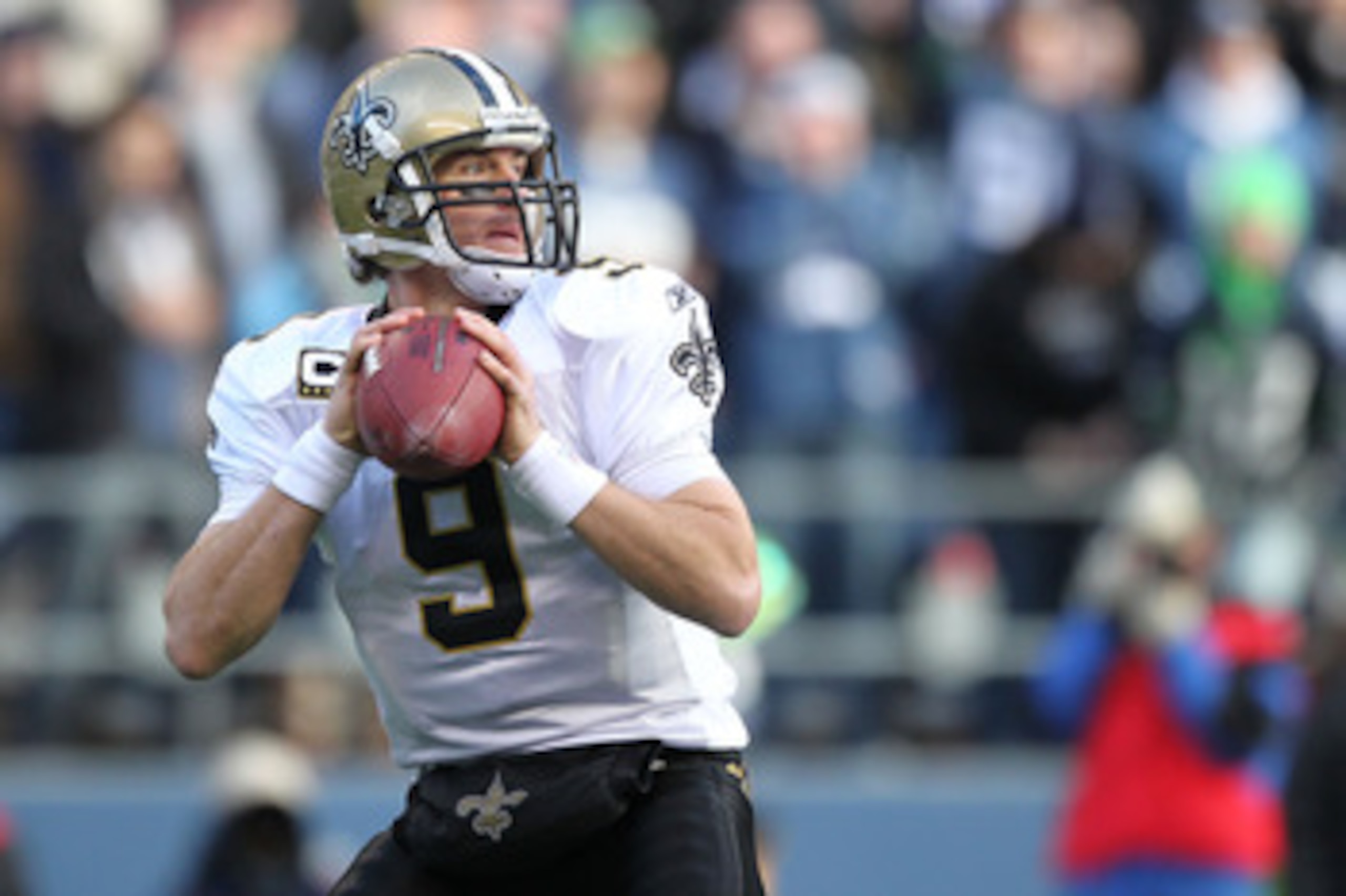 SEATTLE, WA - JANUARY 08:  Quarterback Drew Brees #9 of the New Orleans Saints scrambles against the Seattle Seahawks during the 2011 NFC wild-card playoff game at Qwest Field on January 8, 2011 in Seattle, Washington.  (Photo by Otto Greule Jr/Getty Imag