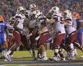 GAINESVILLE, FL - NOVEMBER 13:  Stephen Garcia #5 of the South Carolina Gamecocks is congratulated by teammates after rushing for a touchdown during a game against the Florida Gators at Ben Hill Griffin Stadium on November 13, 2010 in Gainesville, Florida