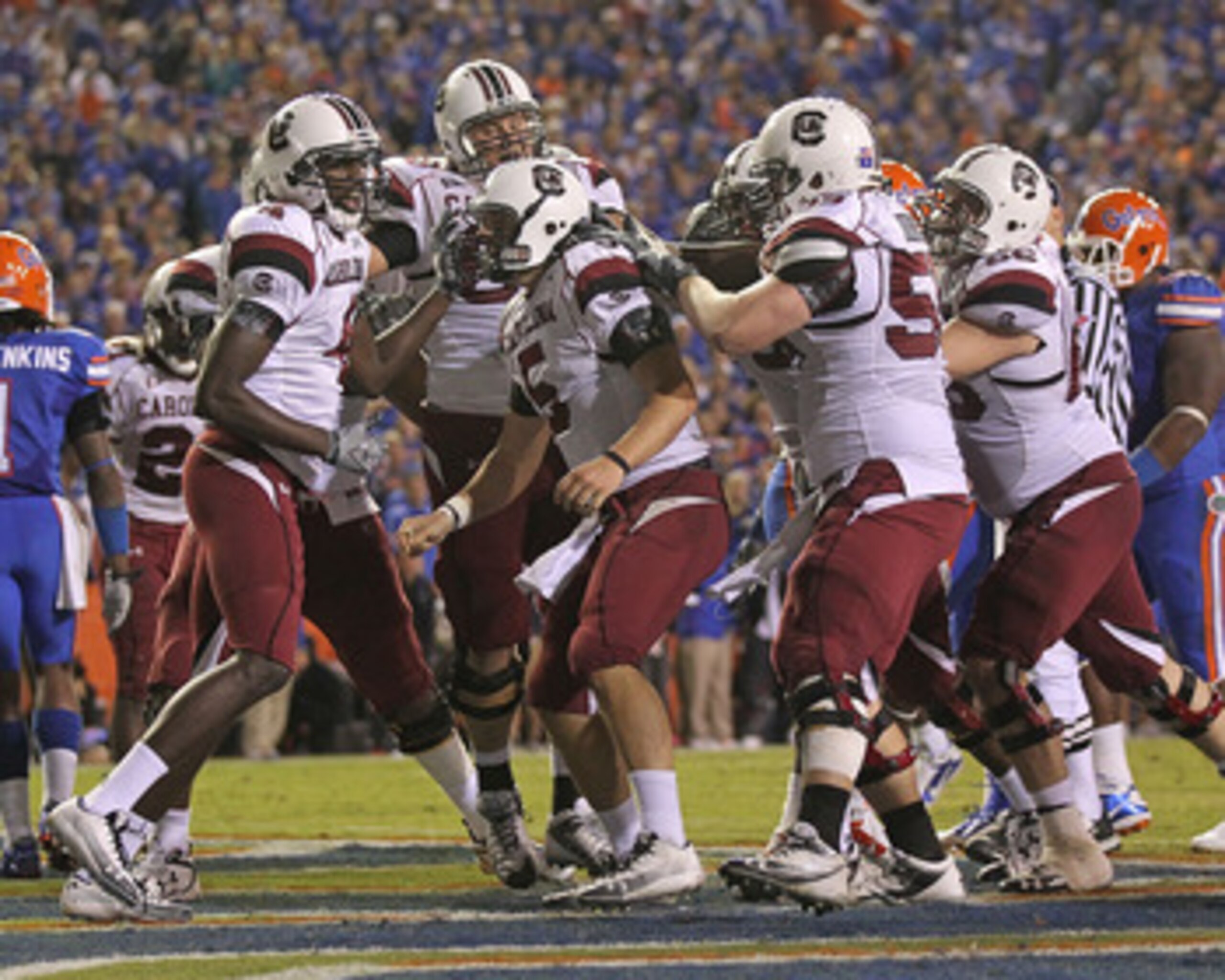 GAINESVILLE, FL - NOVEMBER 13:  Stephen Garcia #5 of the South Carolina Gamecocks is congratulated by teammates after rushing for a touchdown during a game against the Florida Gators at Ben Hill Griffin Stadium on November 13, 2010 in Gainesville, Florida