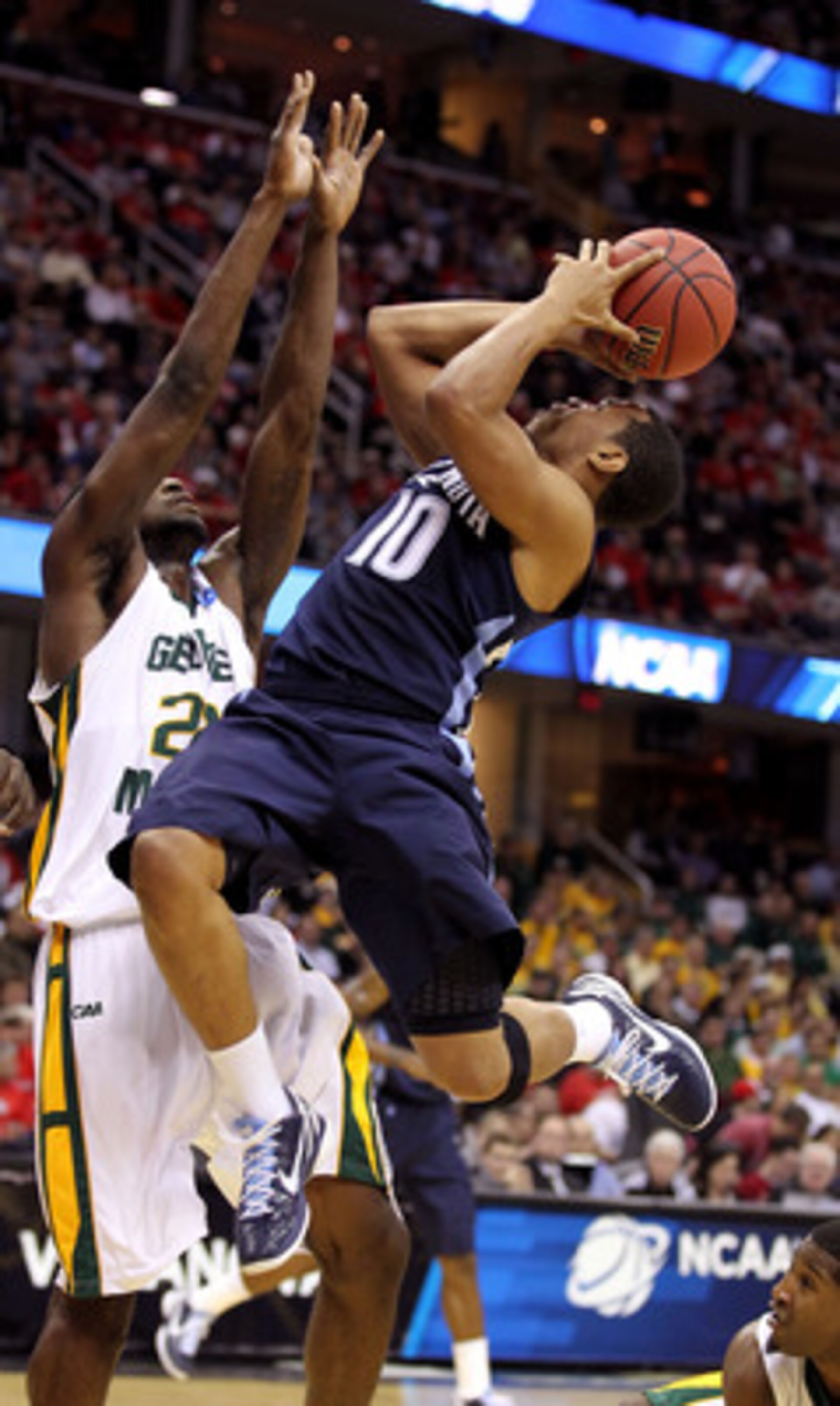 CLEVELAND, OH - MARCH 18: Corey Fisher #10 of the Villanova Wildcats drives to the basket against Mike Morrison #22 of the George Mason Patriots during the second round of the 2011 NCAA men's basketball tournament at Quicken Loans Arena on March 18, 2011