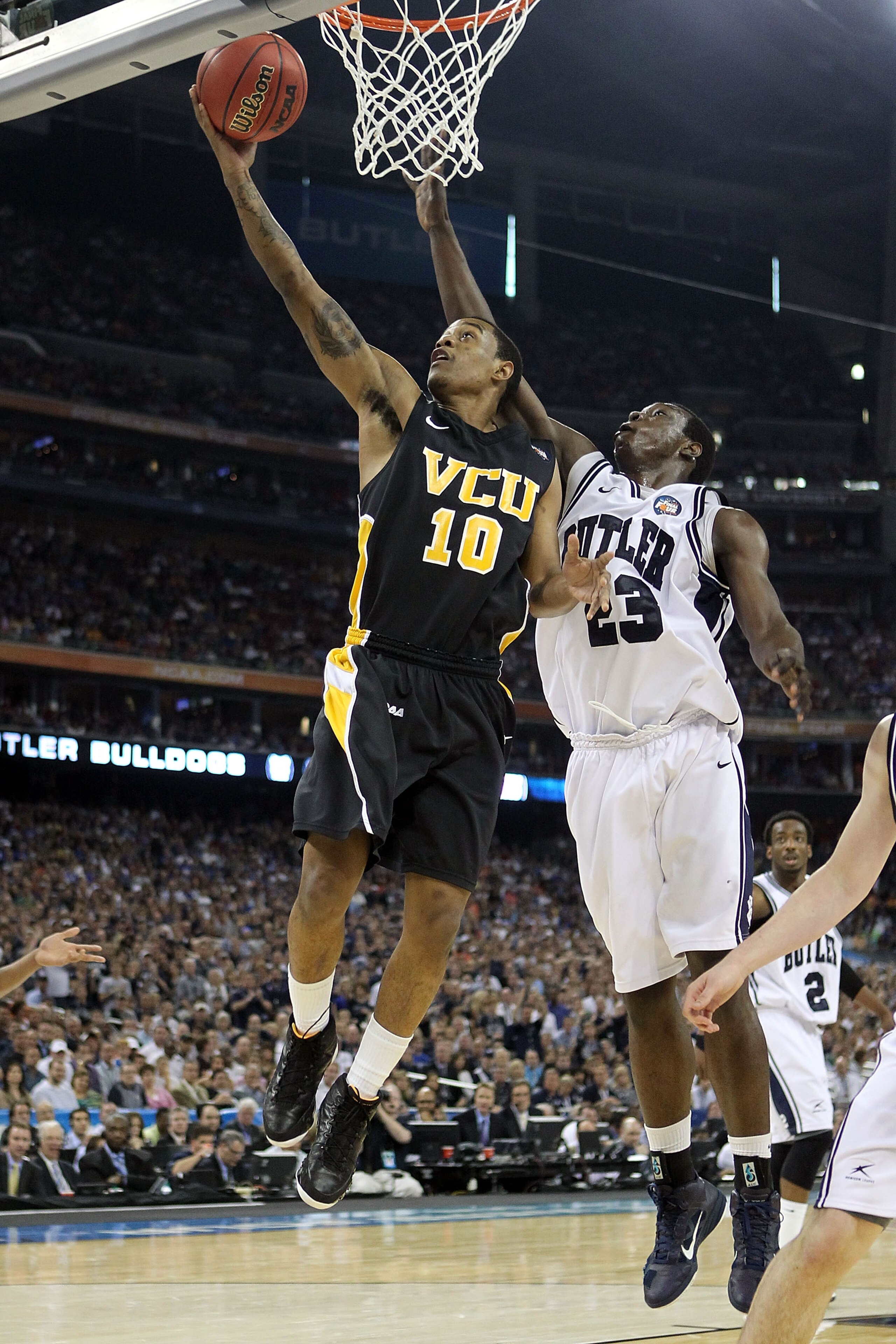 HOUSTON, TX - APRIL 02:  Darius Theus #10 of the Virginia Commonwealth Rams goes to the hoop against Khyle Marshall #23 of the Butler Bulldogs during the National Semifinal game of the 2011 NCAA Division I Men's Basketball Championship at Reliant Stadium