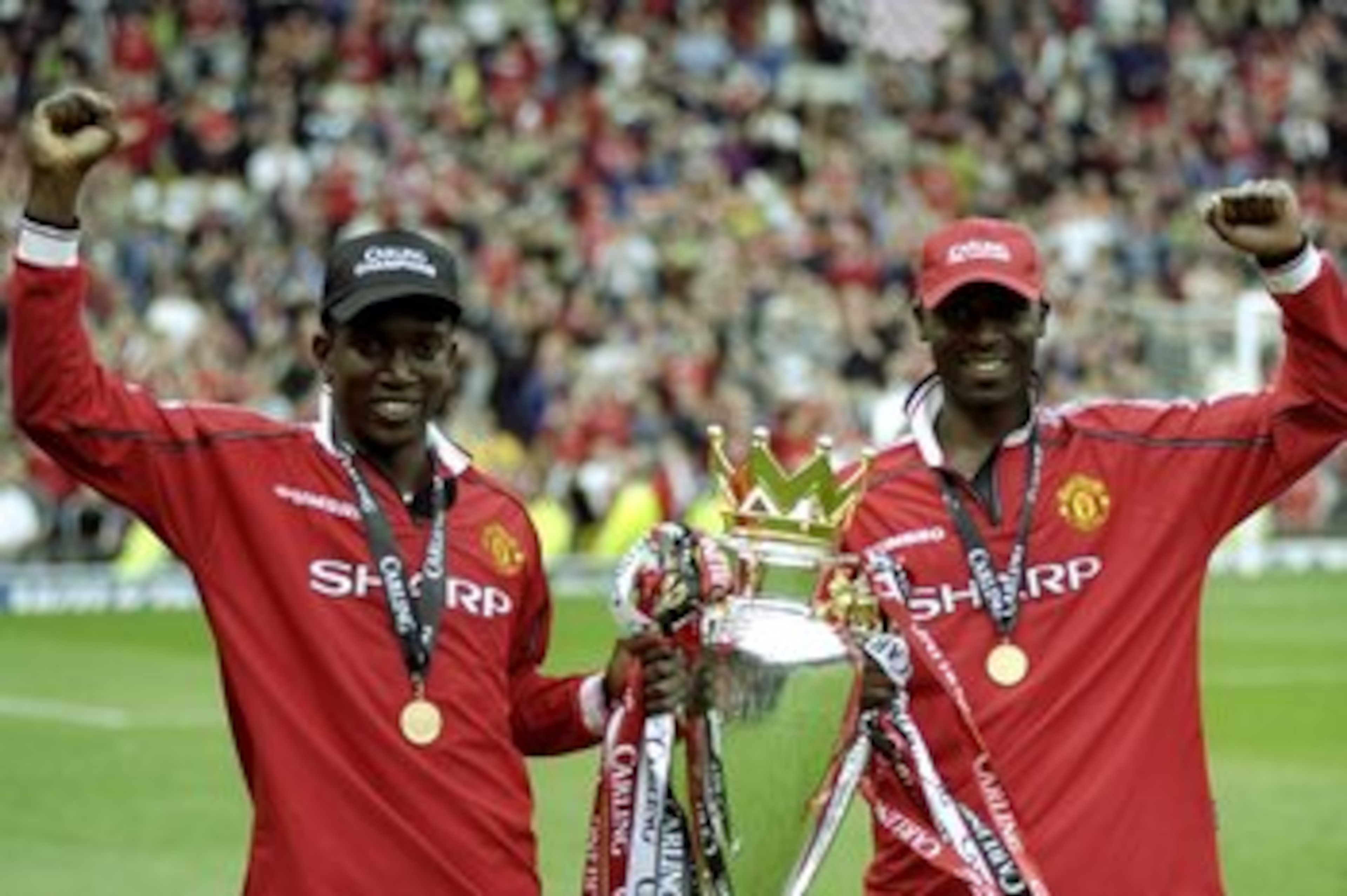 16 May 1999:  Dwight Yorke and Andy Cole of Manchester United celebrate winning the title with the trophy after the FA Carling Premiership match against Tottenham Hotspur played at Old Trafford in Manchester, England.  The match finished in a 2-1 win forM