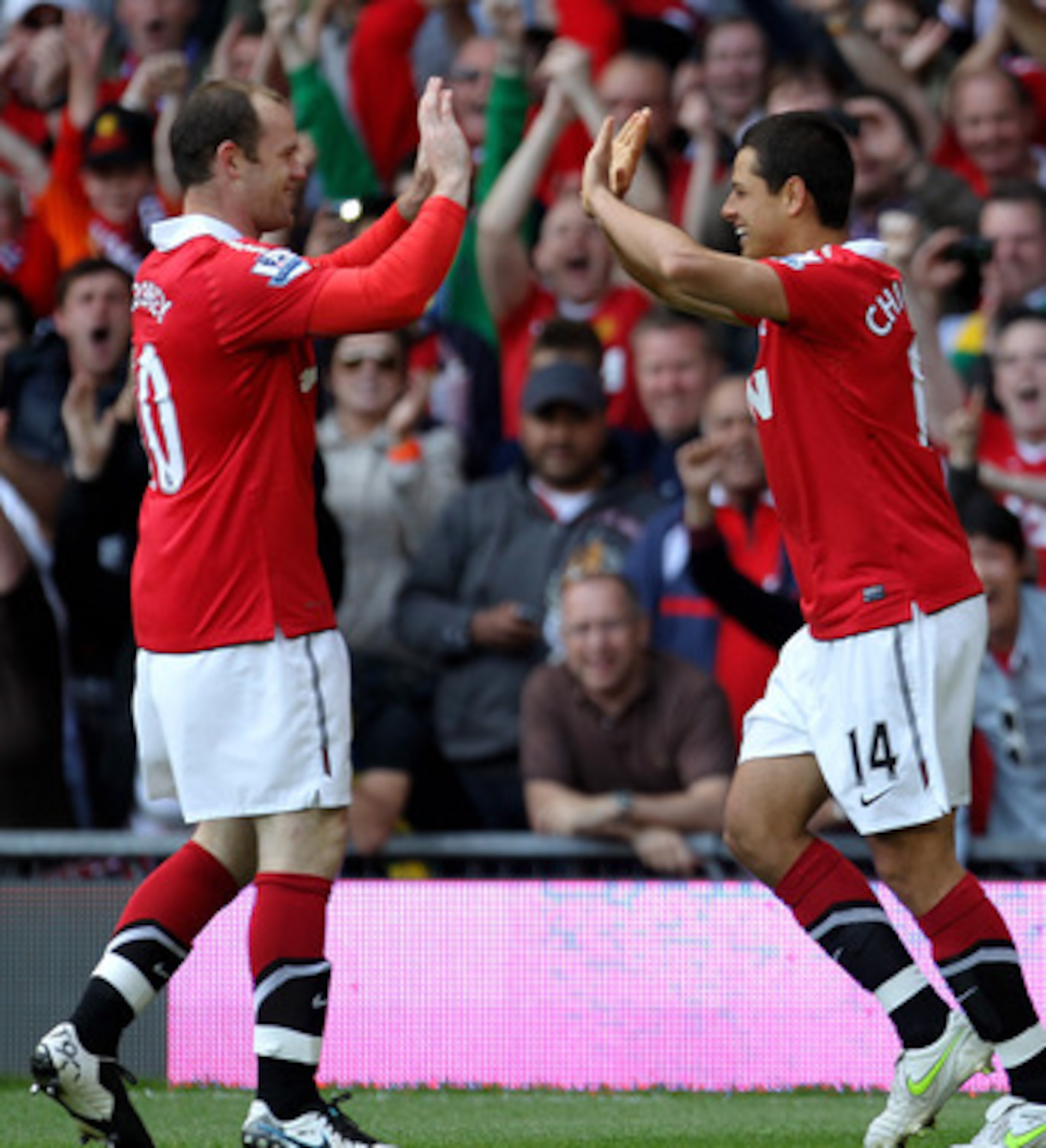 MANCHESTER, ENGLAND - MAY 08:  Javier Hernandez of Manchester United celebrates scoring the opening goal with team mate Wayne Rooney (L) during the Barclays Premier League match between Manchester United and Chelsea at Old Trafford on May 8, 2011 in Manch