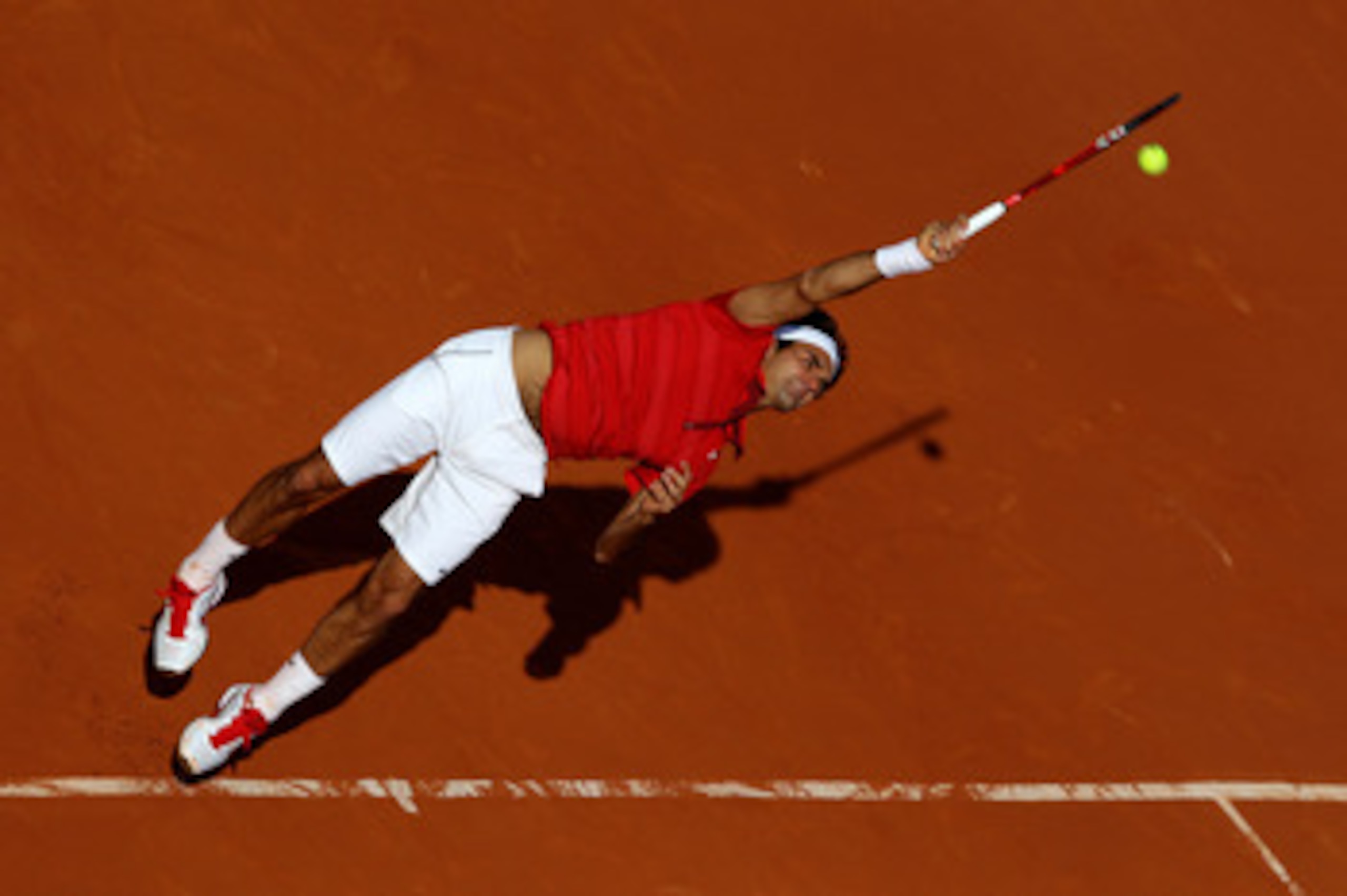 PARIS, FRANCE - MAY 31:  Roger Federer of Switzerland serves during the men's singles quarterfinal match between Gael Monfils of France and Roger Federer of Switzerland on day ten of the French Open at Roland Garros on May 31, 2011 in Paris, France.  (Pho