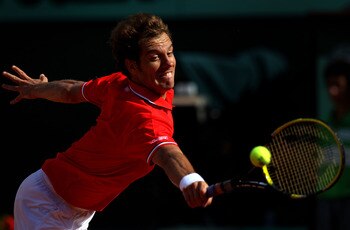 PARIS, FRANCE - MAY 29: Richard Gasquet of France stretches to hit a backhand during the men's singles round four match between Richard Gasquet of France and Novak Djokovic of Serbia on day eight of the French Open at Roland Garros on May 29, 2011 in Par PARIS, FRANCE - MAY 29: Richard Gasquet of France stretches to hit a backhand during the men's singles round four match between Richard Gasquet of France and Novak Djokovic of Serbia on day eight of the French Open at Roland Garros on May 29, 2011 in Par