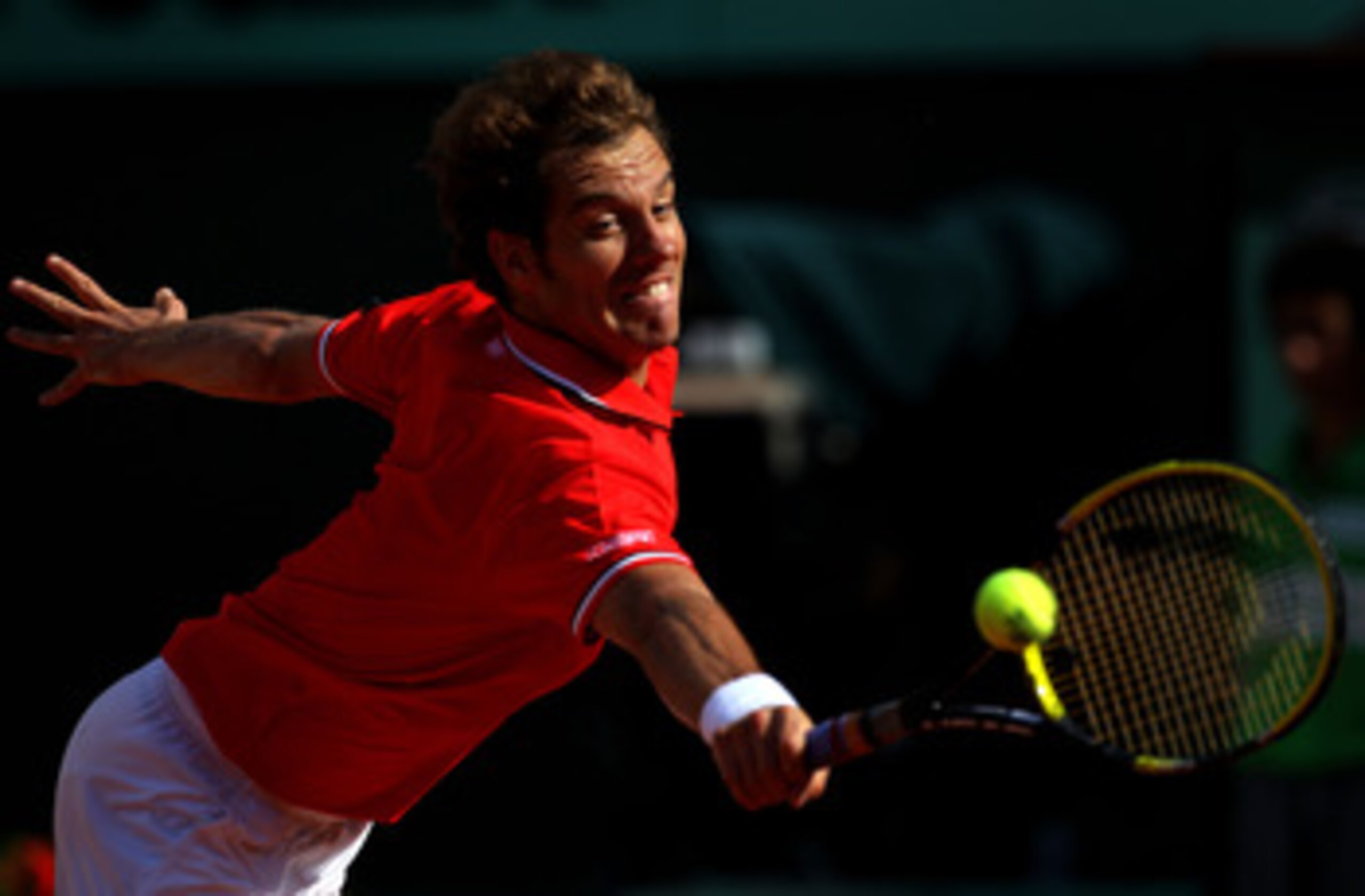 PARIS, FRANCE - MAY 29:  Richard Gasquet of France stretches to hit a backhand during the men's singles round four match between Richard Gasquet of France and Novak Djokovic of Serbia on day eight of the French Open at Roland Garros on May 29, 2011 in Par