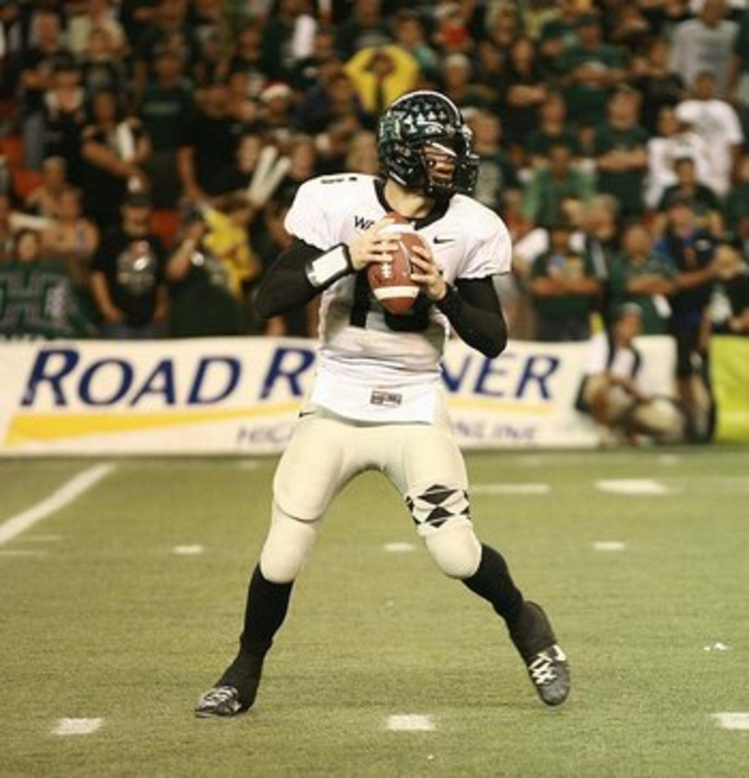HONOLULU - DECEMBER 2: Colt Brennan #15 of the Hawaii Warriors drops back to pass against the Washington Huskies on December 1, 2007 at Aloha Stadium in Honolulu, Hawaii. Hawaii won 35-28 and finished the season undefeated at 12-0. (Photo by William Br HONOLULU - DECEMBER 2: Colt Brennan #15 of the Hawaii Warriors drops back to pass against the Washington Huskies on December 1, 2007 at Aloha Stadium in Honolulu, Hawaii. Hawaii won 35-28 and finished the season undefeated at 12-0. (Photo by William Br