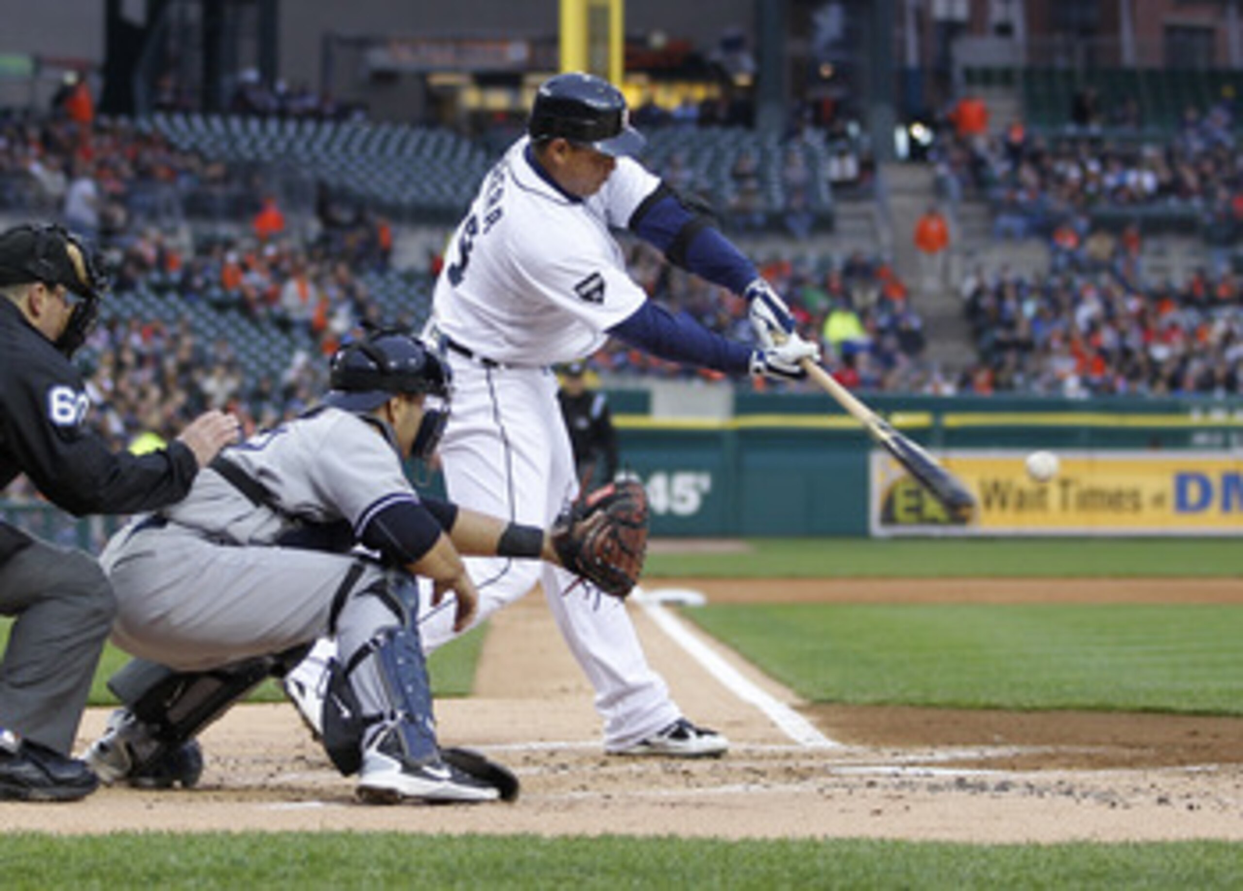 DETROIT, MI - MAY 03: Miguel Cabrera #24 of the Detroit Tigers hits a sacrifice fly to score Scott Sizemore #20 in the first inning in front of Russell Martin #55 of the New York Yankees at Comerica Park on May 3, 2011 in Detroit, Michigan. Detroit won th