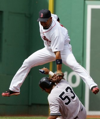 BOSTON - AUGUST 18:  Alex Gonzalez #11 of the Boston Red Sox is late with the tag as Bobby Abreu #53 of the New York Yankees safely steals second on August 18, 2006 at Fenway Park in Boston Massachusetts.  (Photo by Jim McIsaac/Getty Images)