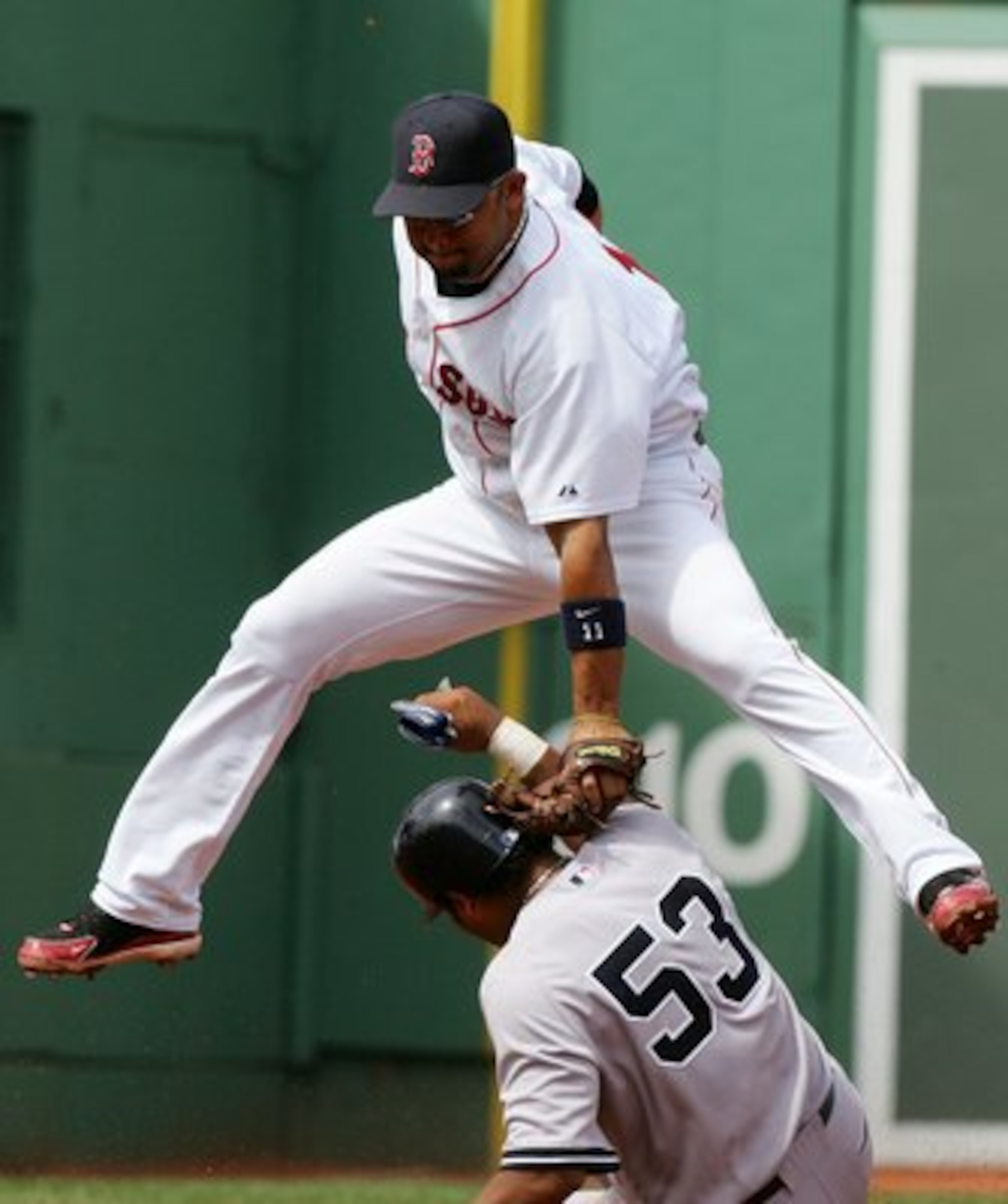 BOSTON - AUGUST 18:  Alex Gonzalez #11 of the Boston Red Sox is late with the tag as Bobby Abreu #53 of the New York Yankees safely steals second on August 18, 2006 at Fenway Park in Boston Massachusetts.  (Photo by Jim McIsaac/Getty Images)