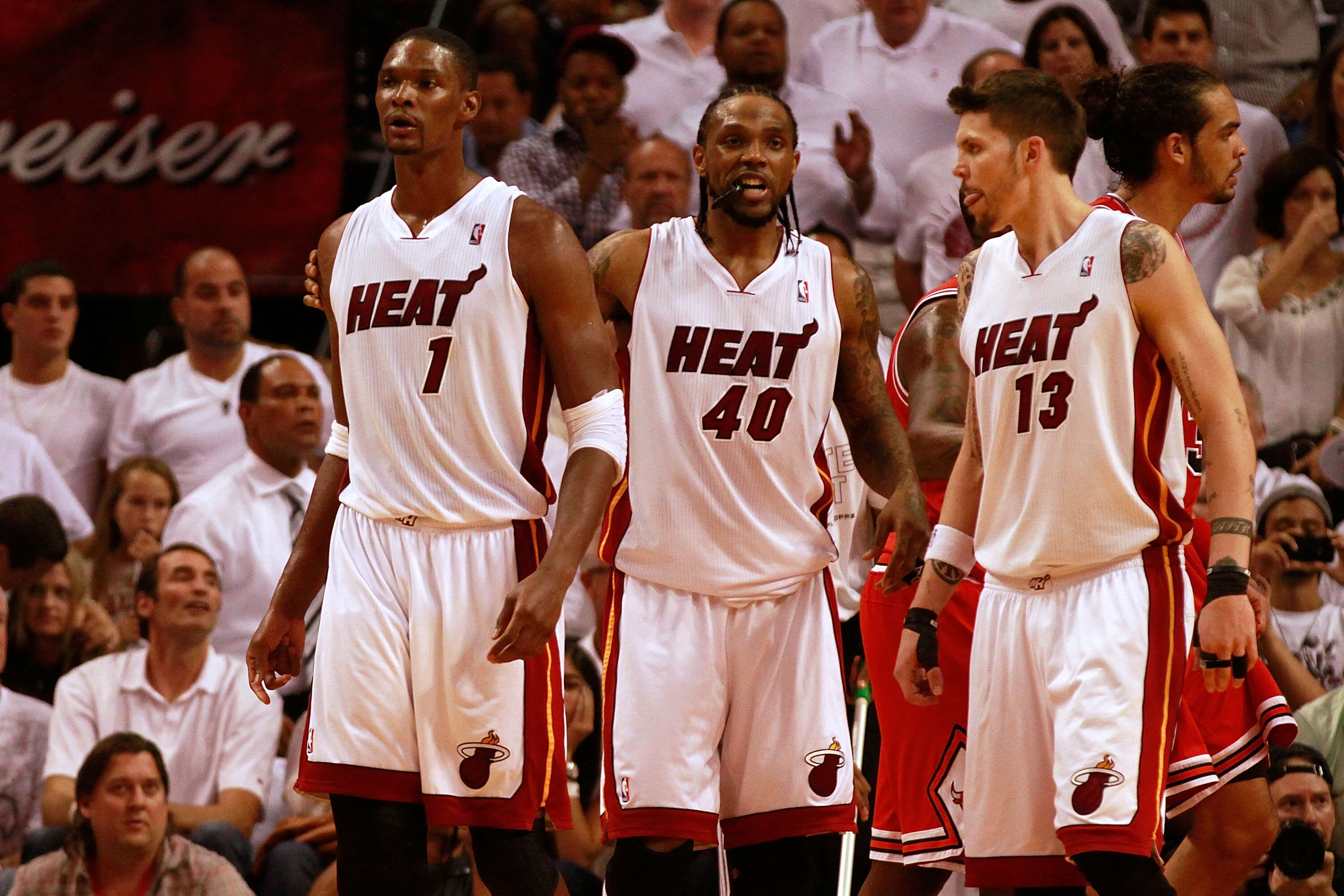 MIAMI, FL - MAY 24: (L-R) Chris Bosh #1, Udonis Haslem #40 and Mike Miller #13 of the Miami Heat look on against the Chicago Bulls in Game Four of the Eastern Conference Finals during the 2011 NBA Playoffs on May 24, 2011 at American Airlines Arena in Mia