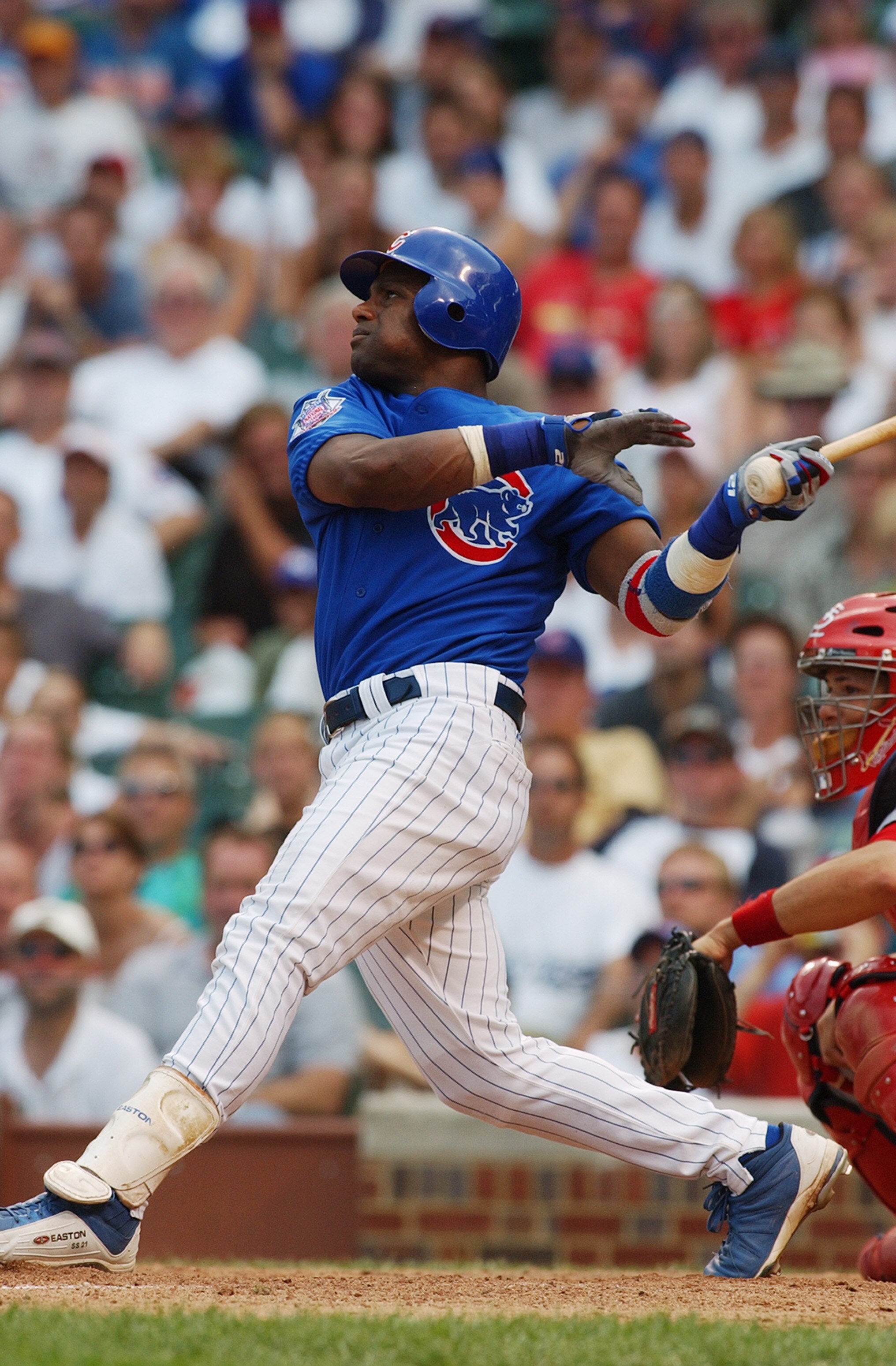 CHICAGO - JULY 20:  Sammy Sosa #21 of the Chicago Cubs watches the flight of the ball as he follows through on a swing during the game against the St. Louis Cardinals at Wrigley Field on July 20, 2004 in Chicago, Illinois. The Cardinals defeated the Cubs