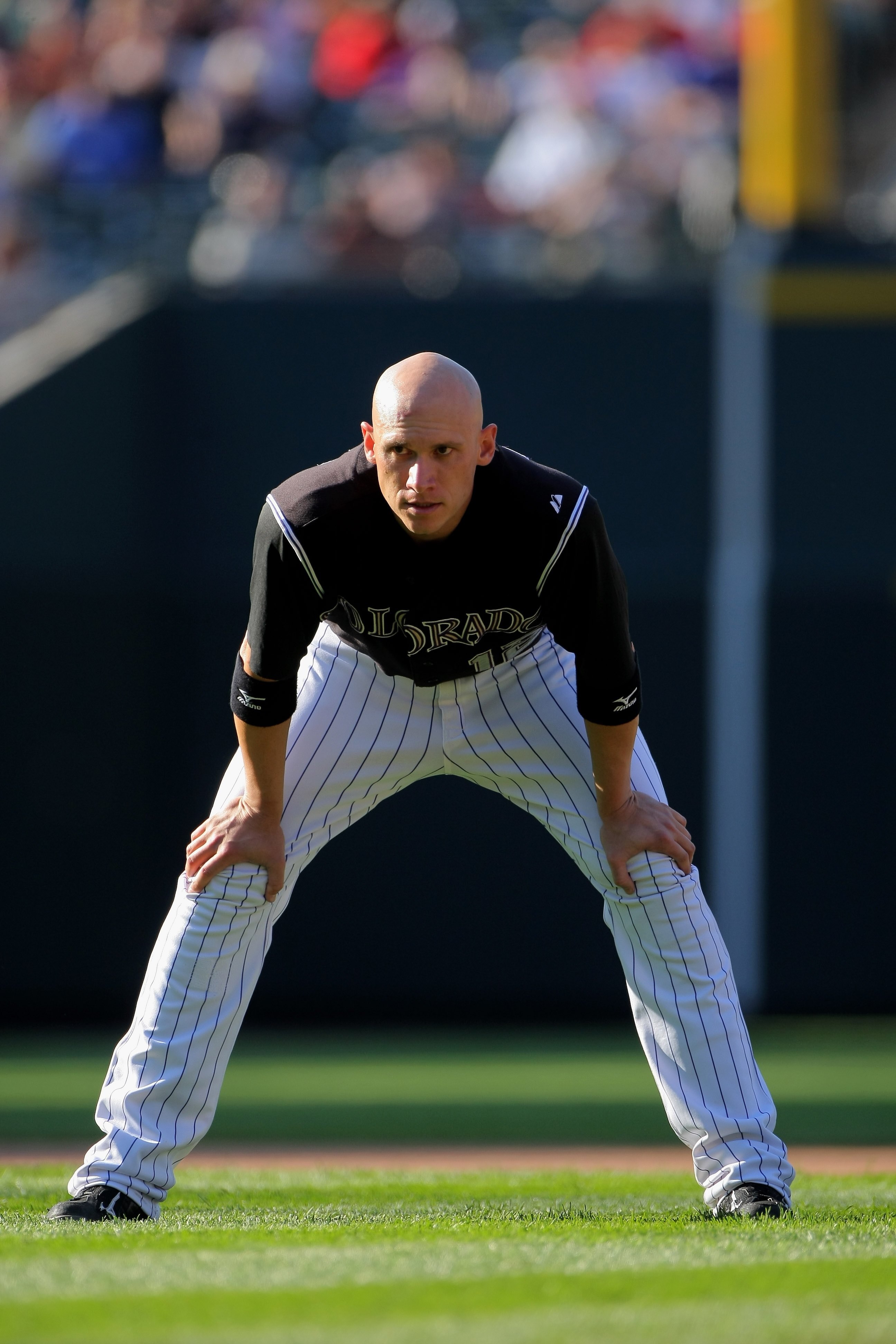 DENVER - SEPTEMBER 27:  Clint Barmes #12 of the Colorado Rockies looks on during a break in the action against the St. Louis Cardinals at Coors Field on September 27, 2009 in Denver, Colorado. The Rockies defeated the Cardinals 4-3.  (Photo by Doug Pensin