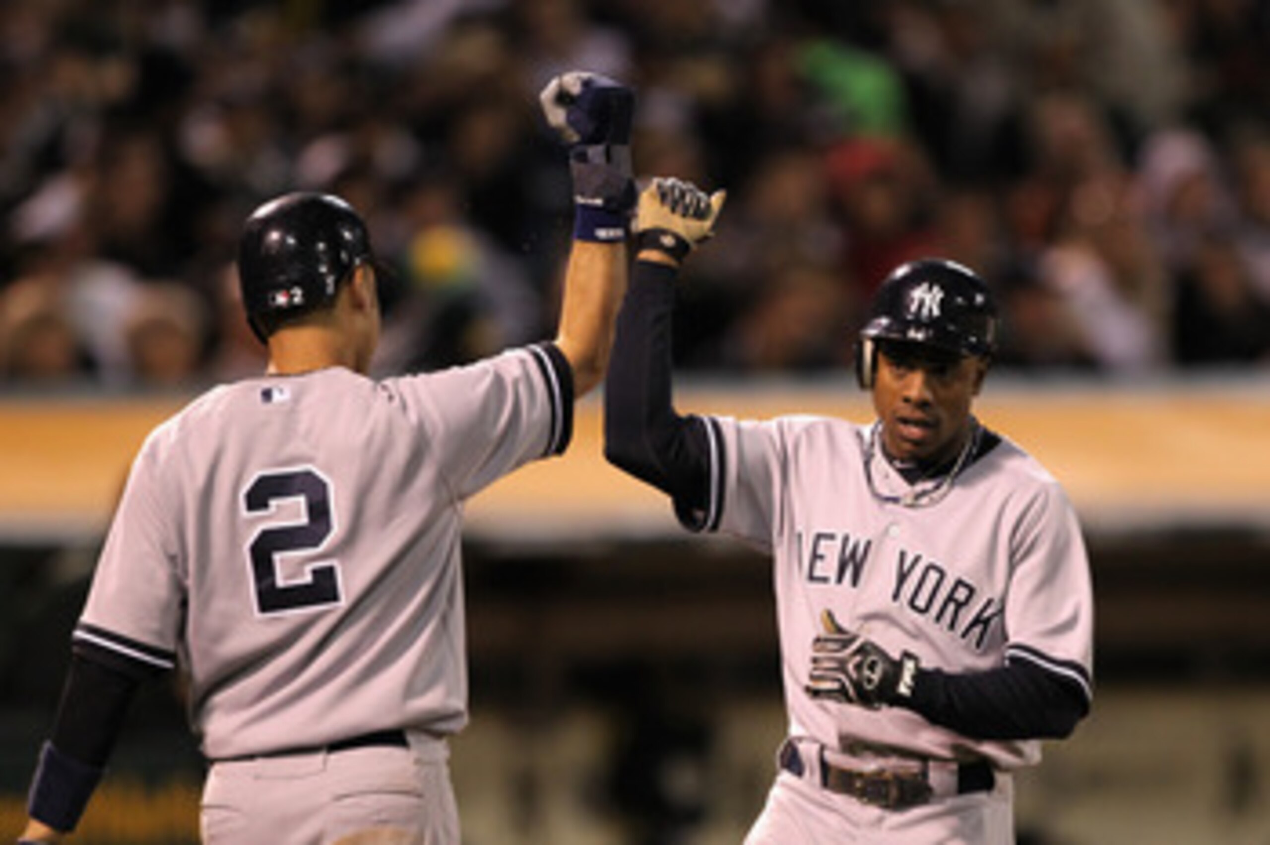 OAKLAND, CA - MAY 31:  Derek Jeter #2 and Curtis Granderson #14 of the New York Yankees congratulate one another after they scored on a single by Alex Rodriguez #13 of the New York Yankees in the sixth inning against the the Oakland Athletics at Oakland-A