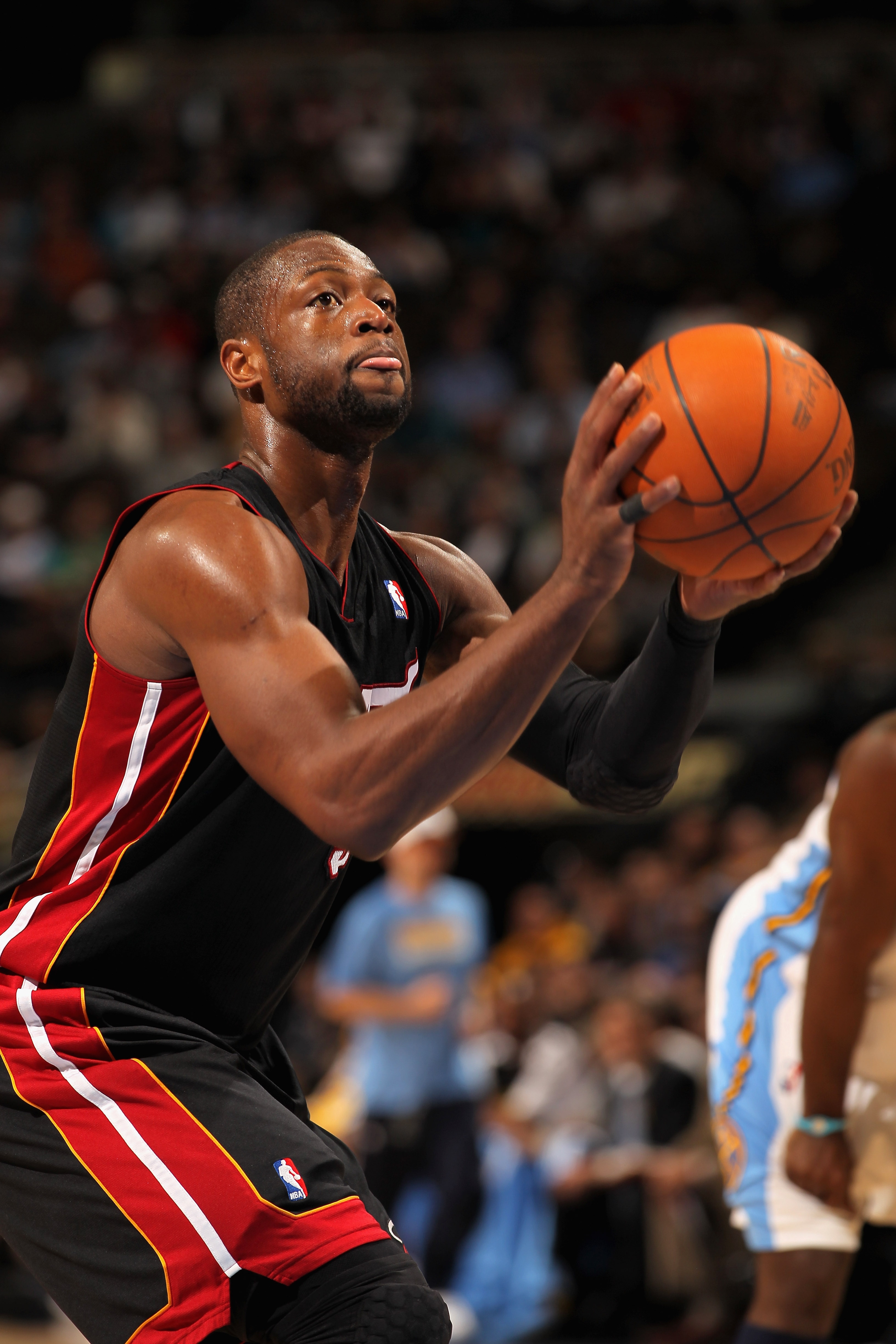 DENVER, CO - JANUARY 13:  Dwayne Wade #3 of the Miami Heat takes a free throw against the Denver Nuggets at the Pepsi Center on January 13, 2011 in Denver, Colorado. The Nuggets defeated the Heat 130-102. NOTE TO USER: User expressly acknowledges and agre