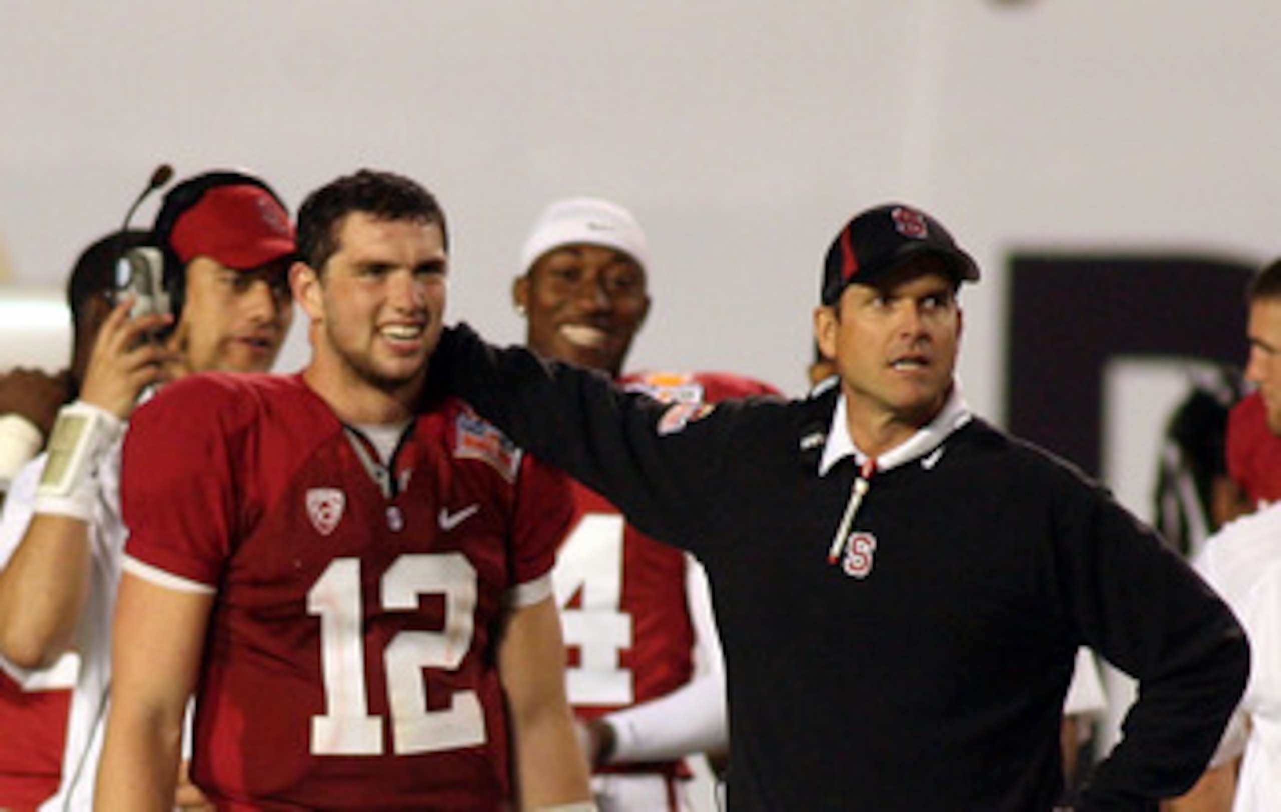 MIAMI, FL - JANUARY 03:  (L-R) Quarterback Andrew Luck #12 and head coach Jim Harbaugh of the Stanford Cardinal look on from the sideline late in the fourth quarter against the Virginia Tech Hokies during the 2011 Discover Orange Bowl at Sun Life Stadium 