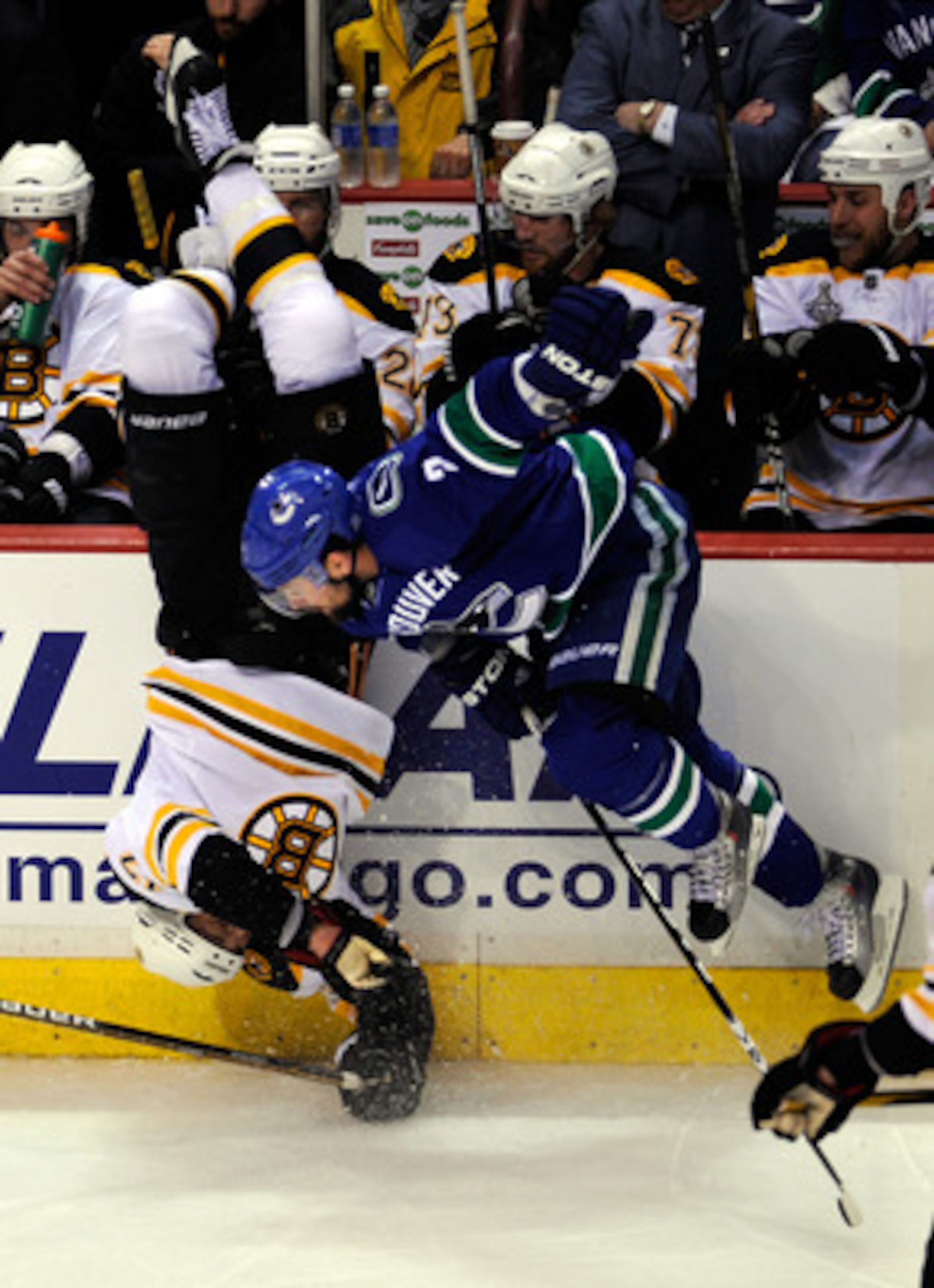 VANCOUVER, BC - JUNE 01:  Milan Lucic #17 of the Boston Bruins gets flipped after being check by Dan Hamhuis #2 of the Vancouver Canucks during game one of the 2011 NHL Stanley Cup Finals at Rogers Arena on June 1, 2011 in Vancouver, Canada.  (Photo by Ri