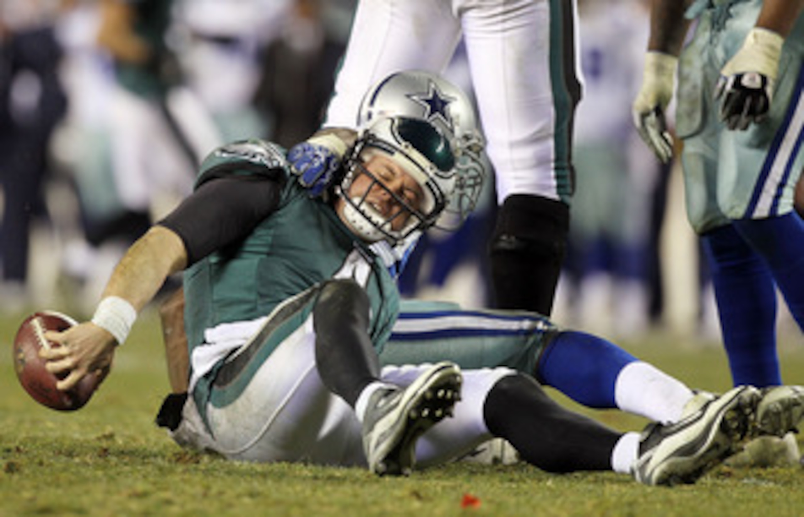 PHILADELPHIA, PA - JANUARY 02:  Kevin Kolb #4 of the Philadelphia Eagles is sacked by DeMarcus Ware #94 of the Dallas Cowboys on January 2, 2011 at Lincoln Financial Field in Philadelphia, Pennsylvania. The Cowboys defeated the Eagles 14-13.  (Photo by Ji