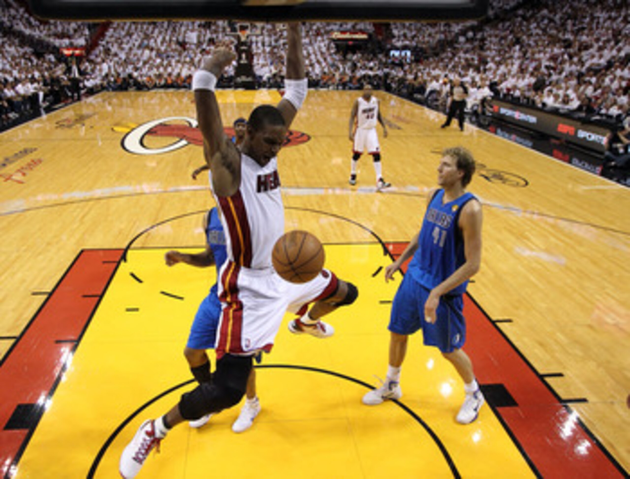 MIAMI, FL - JUNE 02:  Chris Bosh #1 of the Miami Heat dunks against Dirk Nowitzki #41 of the Dallas Mavericks in Game Two of the 2011 NBA Finals at American Airlines Arena on June 2, 2011 in Miami, Florida. NOTE TO USER: User expressly acknowledges and ag