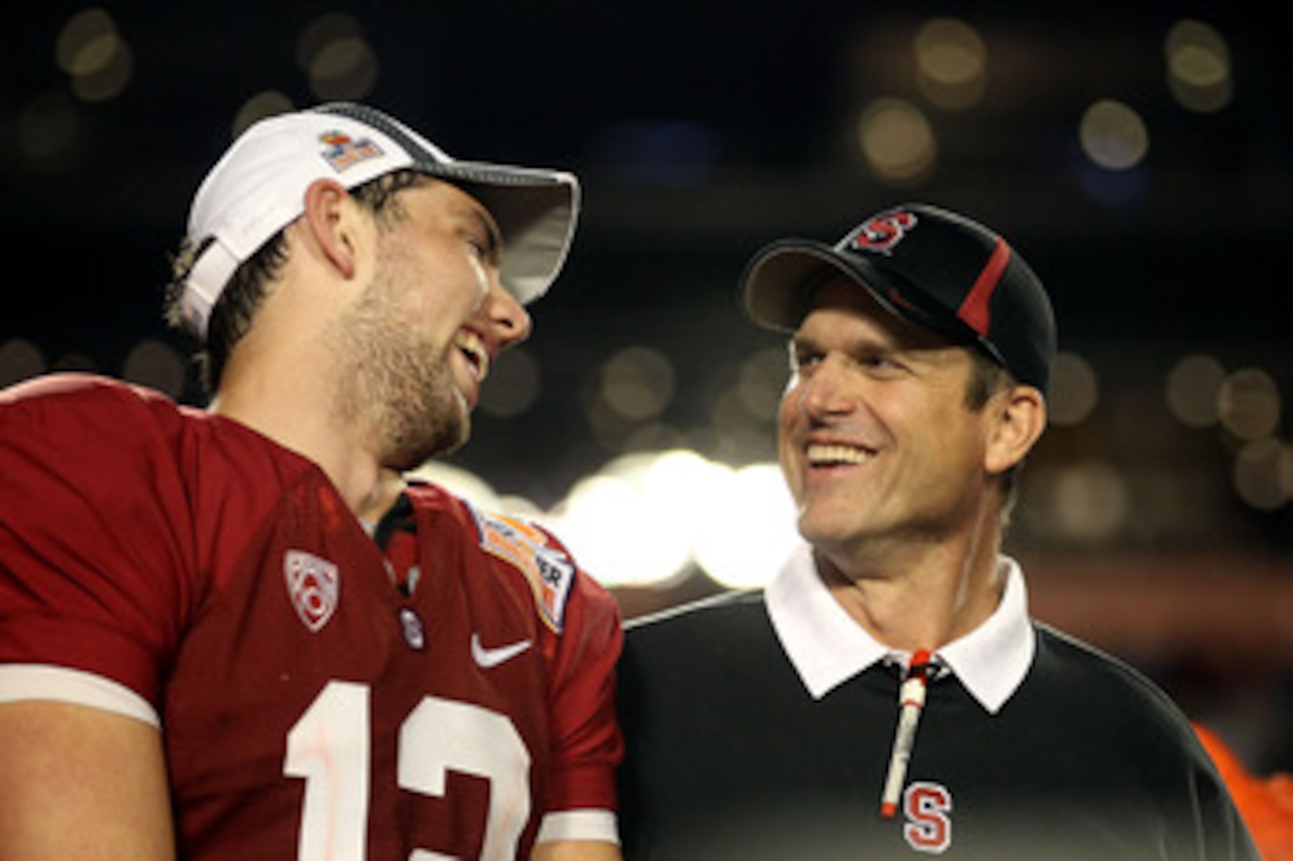 MIAMI, FL - JANUARY 03:  (L-R) Quarterback Andrew Luck and head coach Jim Harbaugh of the Stanford Cardinal celebrate on stage after Stanford won 40-12 against the Virginai Tech Hokies during the 2011 Discover Orange Bowl at Sun Life Stadium on January 3,