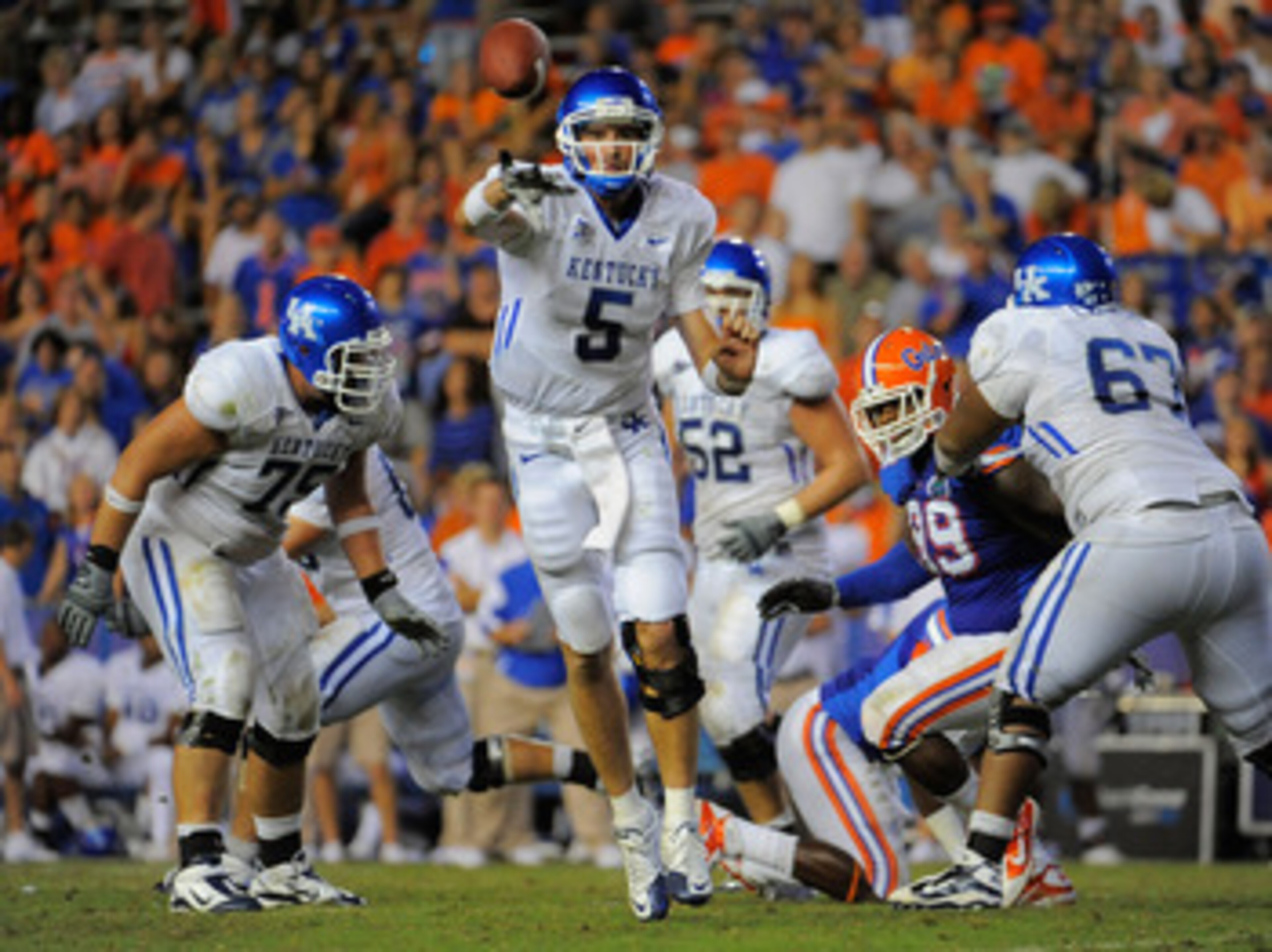 GAINESVILLE, FL - SEPTEMBER 25:  Quarterback Mike Hartline #5 of the Kentucky Wildcats throws a pass against the Florida Gators at Ben Hill Griffin Stadium on September 25, 2010 in Gainesville, Florida. Florida defeated Kentucky 48-14 for head coach Urban