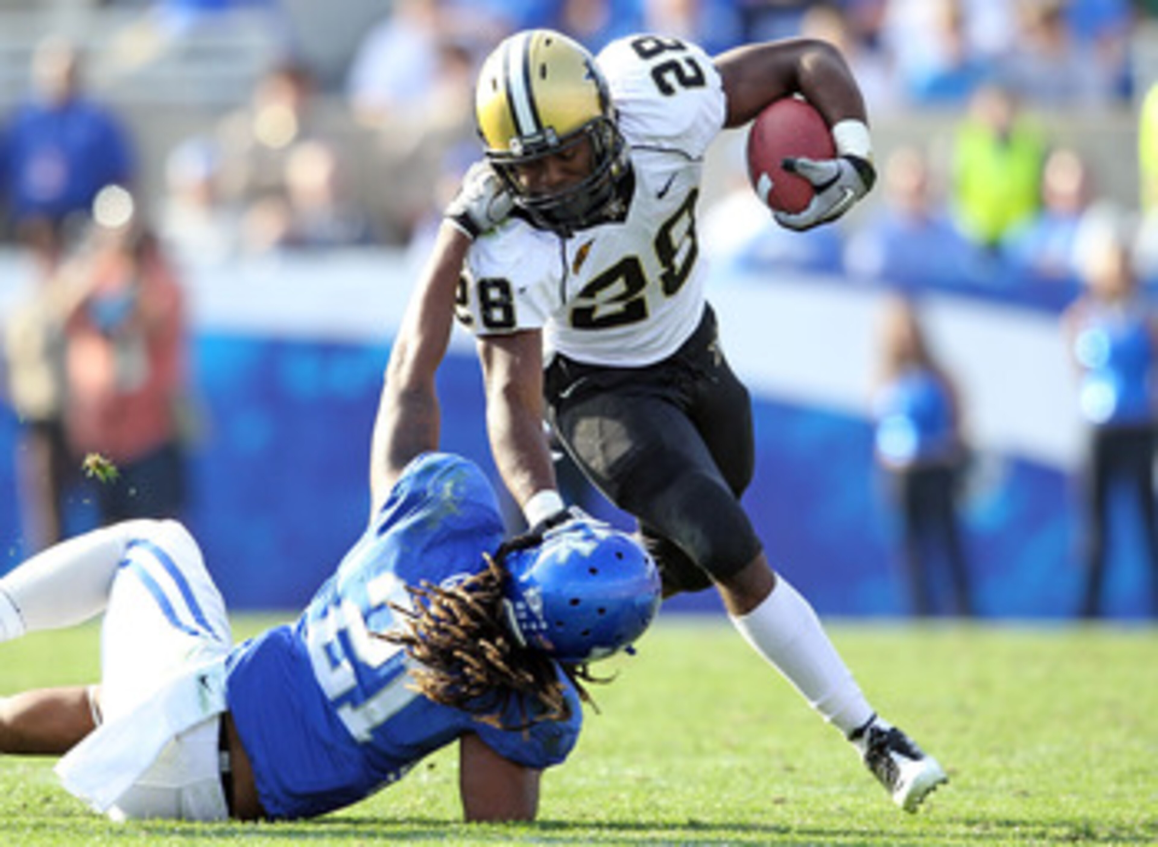 LEXINGTON, KY - NOVEMBER 13:  Kennard Reeves # 28 of the Vanderbilt Commodores is tackled by Winston Guy #21 of the Kentucky Wildcats during the game at Commonwealth Stadium on November 13, 2010 in Lexington, Kentucky.  (Photo by Andy Lyons/Getty Images)