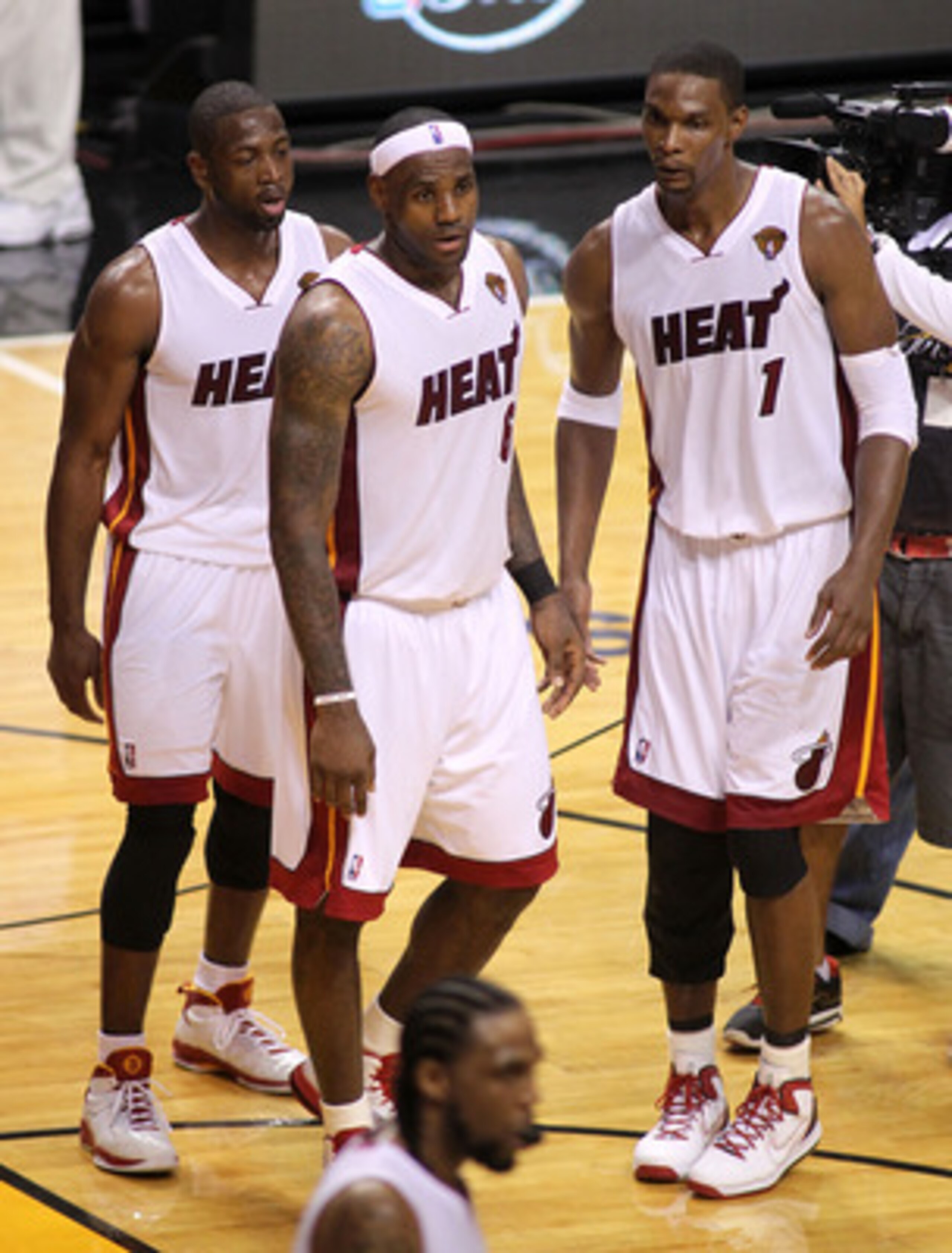MIAMI, FL - MAY 31:  Dwyane Wade #3, LeBron James #6 and Chris Bosh #1 of the Miami Heat react after the Heat defeat the Dallas Mavericks 92-84 in Game One of the 2011 NBA Finals at American Airlines Arena on May 31, 2011 in Miami, Florida. NOTE TO USER: 