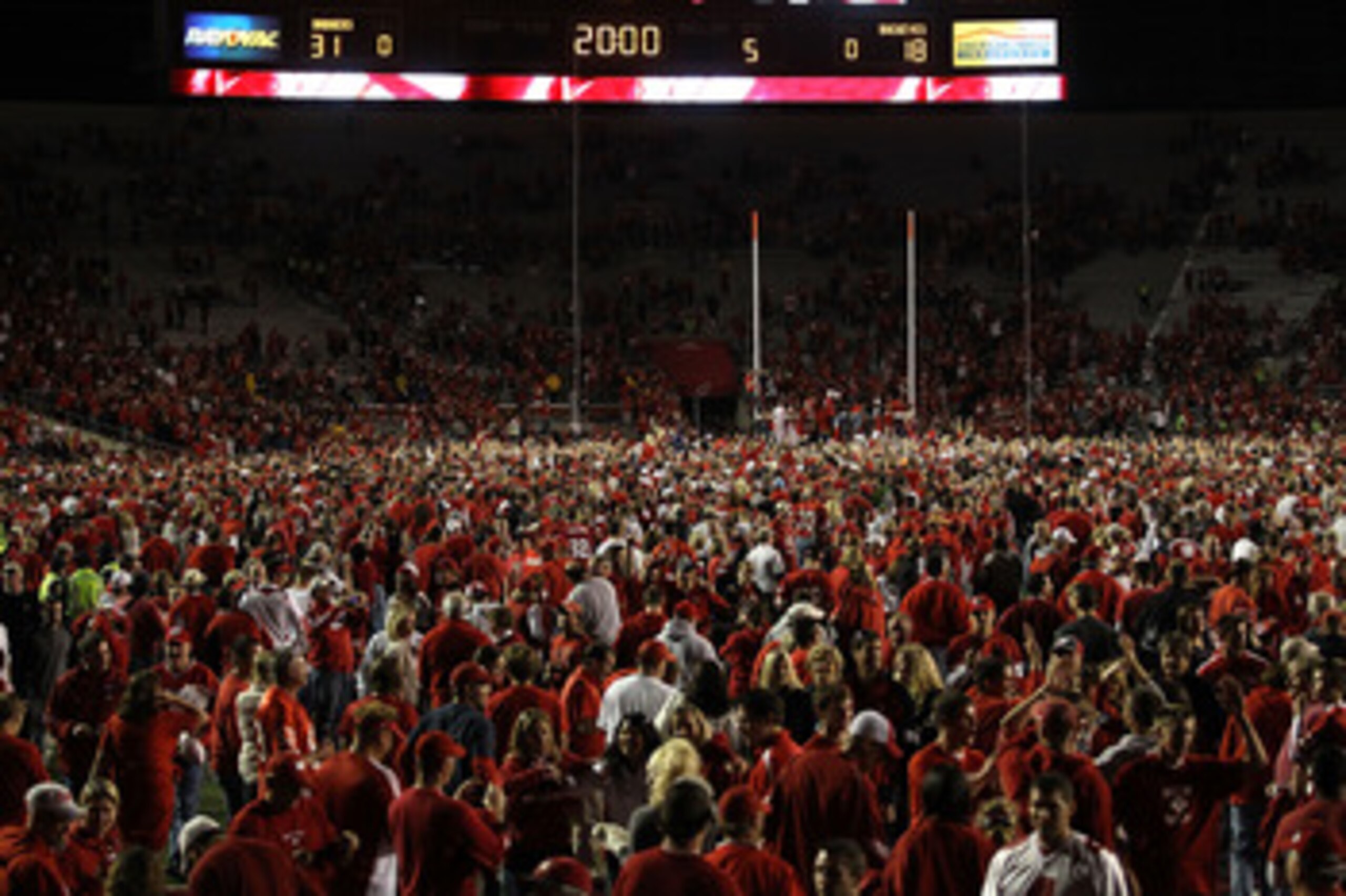 MADISON, WI - OCTOBER 16: Fans of the Wisconsin Badgers storm the field after a win over the Ohio State Buckeyes at Camp Randall Stadium on October 16, 2010 in Madison, Wisconsin. Wisconsin defeated Ohio State 31-18. (Photo by Jonathan Daniel/Getty Images