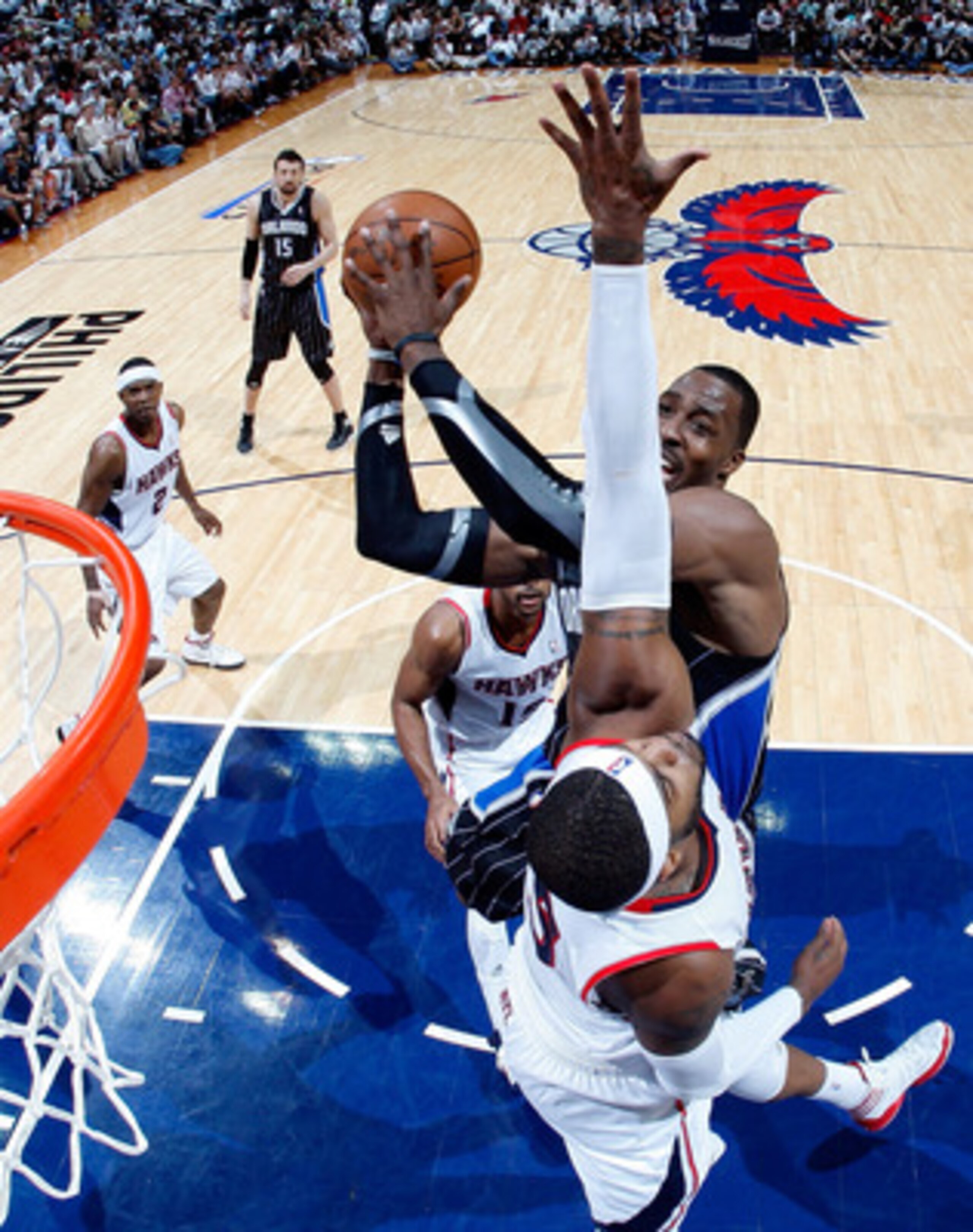 ATLANTA, GA - APRIL 24:  Dwight Howard #12 of the Orlando Magic attacks the basket against Josh Smith #5 of the Atlanta Hawks during Game Four of the Eastern Conference Quarterfinals in the 2011 NBA Playoffs at Philips Arena on April 24, 2011 in Atlanta, 