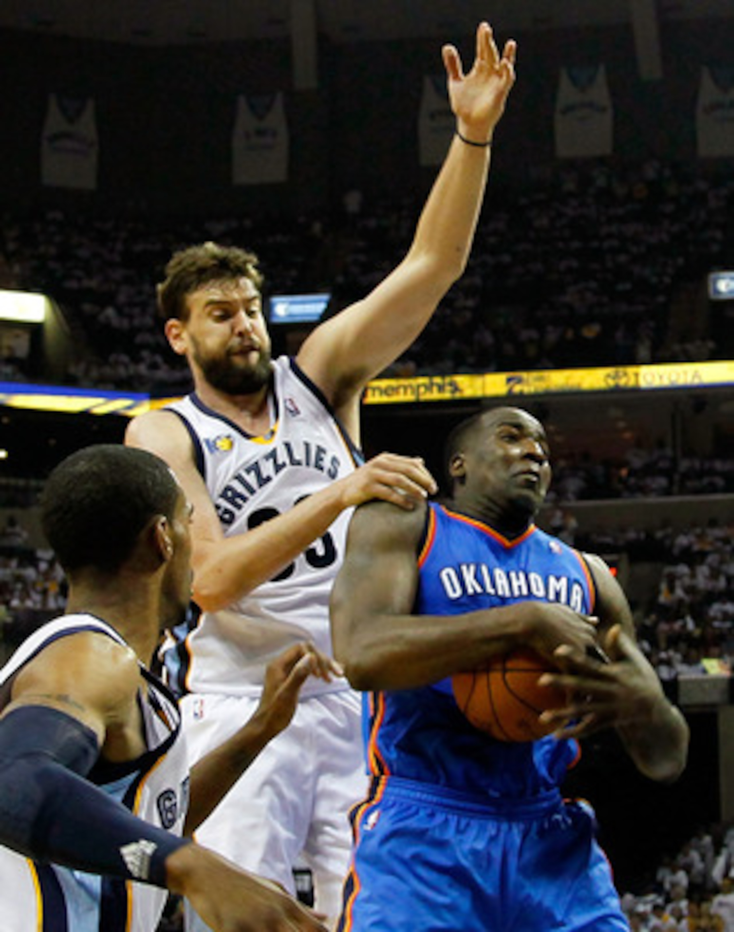 MEMPHIS, TN - MAY 13:  Kendrick Perkins #5 of the Oklahoma City Thunder grabs a rebound against Marc Gasol #33 and Mike Conley #11 of the Memphis Grizzlies in Game Six of the Western Conference Semifinals in the 2011 NBA Playoffs at FedExForum on May 13, 