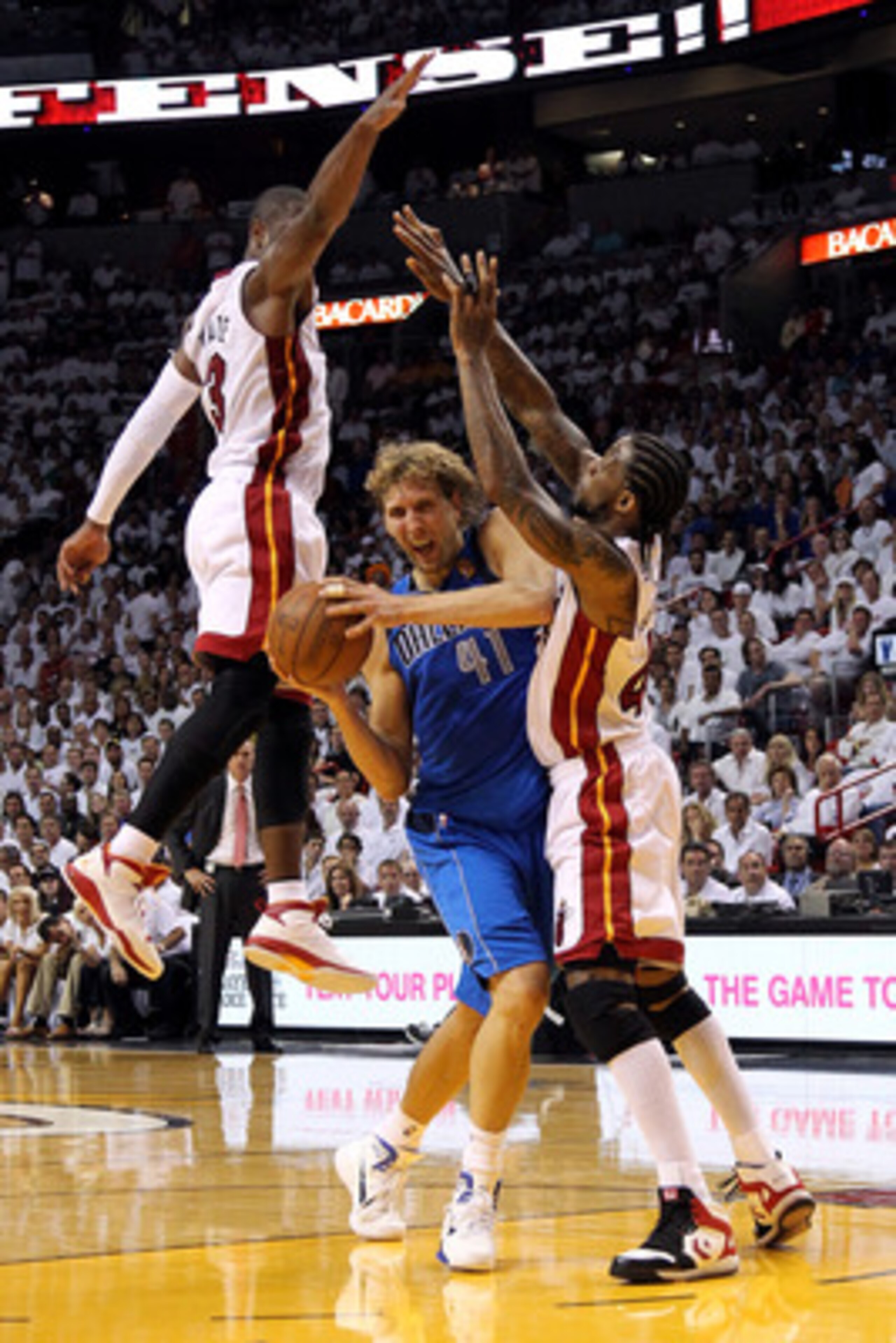MIAMI, FL - JUNE 02:  Dirk Nowitzki #41 of the Dallas Mavericks drives against Udonis Haslem #40 and Dwyane Wade #3 of the Miami Heat in Game Two of the 2011 NBA Finals at American Airlines Arena on June 2, 2011 in Miami, Florida. NOTE TO USER: User expre