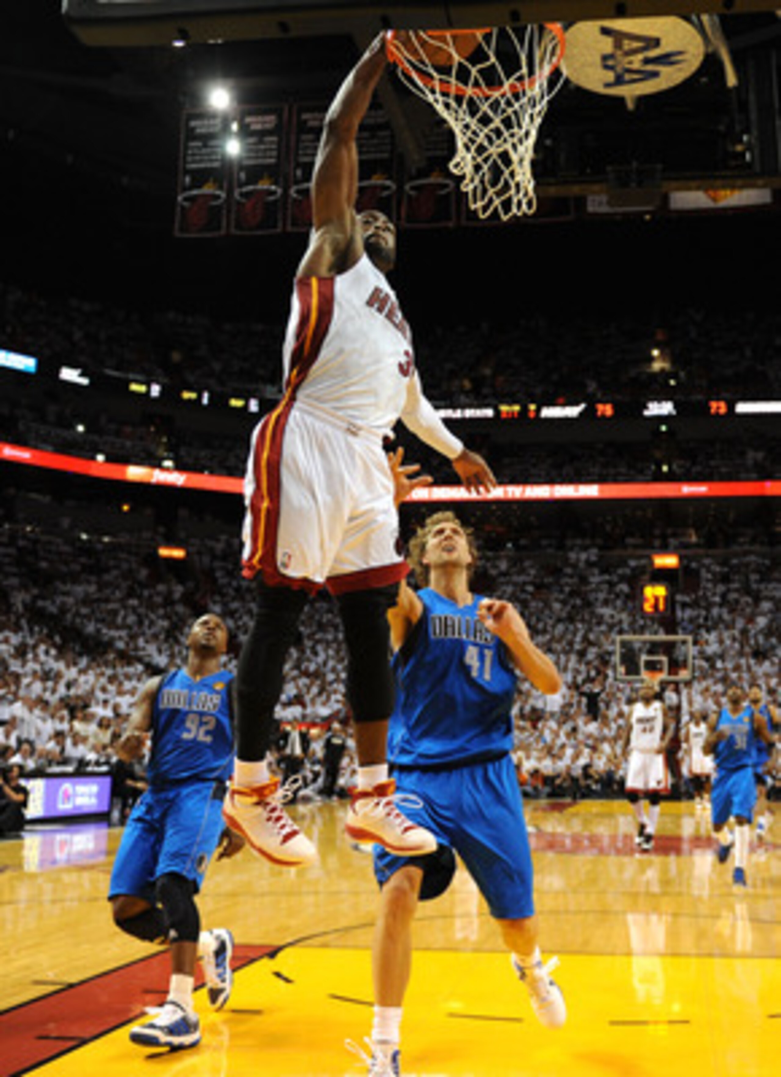MIAMI, FL - JUNE 02:  Dwyane Wade #3 of the Miami Heat dunks against Dirk Nowitzki #41 of the Dallas Mavericks in Game Two of the 2011 NBA Finals at American Airlines Arena on June 2, 2011 in Miami, Florida. The Mavericks won 95-93. NOTE TO USER: User exp