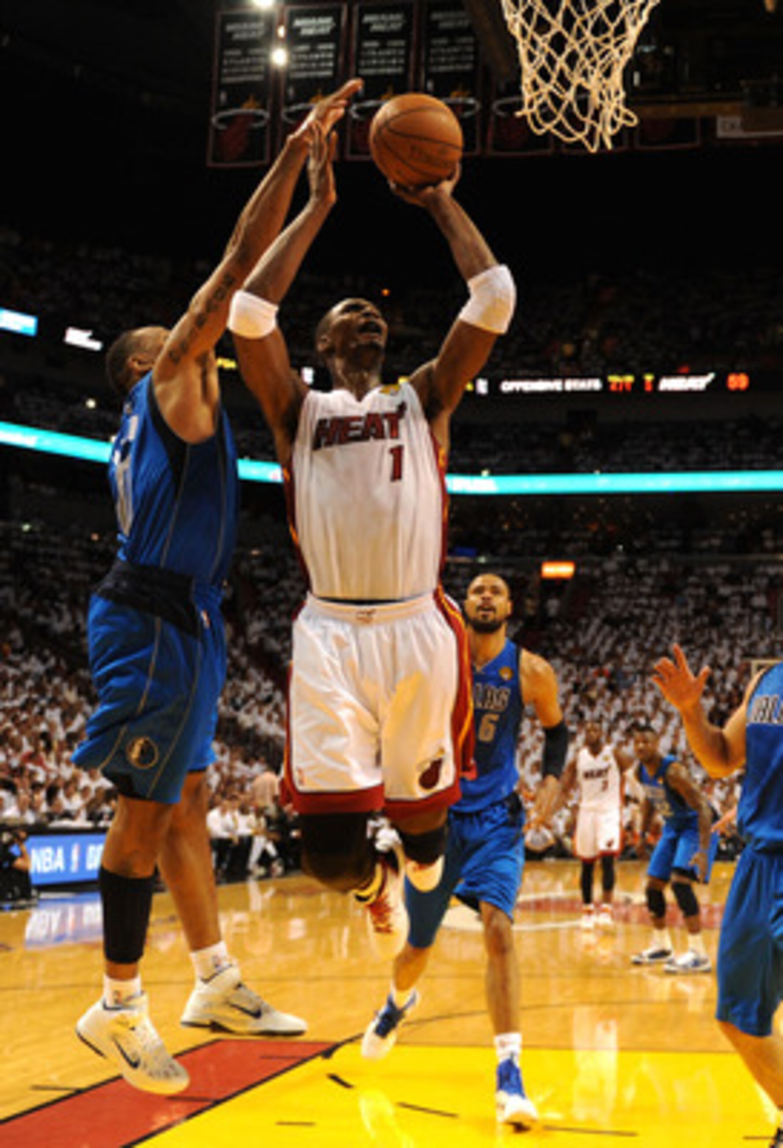 MIAMI, FL - JUNE 02:  Chris Bosh #1 of the Miami Heat attempts a shot against Shawn Marion #0 of the Dallas Mavericks in Game Two of the 2011 NBA Finals at American Airlines Arena on June 2, 2011 in Miami, Florida. The Mavericks won 95-93. NOTE TO USER: U