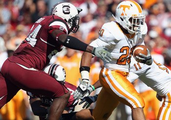 COLUMBIA, SC - OCTOBER 30:  Rajion Neal #28 of the Tennessee Volunteers is tackled by Tony Straughter #44 of the South Carolina Gamecocks during their game at Williams-Brice Stadium on October 30, 2010 in Columbia, South Carolina.  (Photo by Streeter Leck