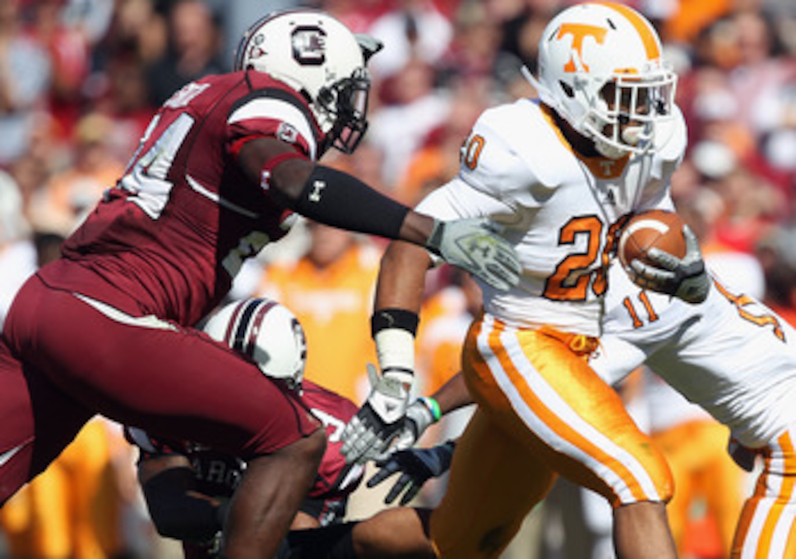 COLUMBIA, SC - OCTOBER 30:  Rajion Neal #28 of the Tennessee Volunteers is tackled by Tony Straughter #44 of the South Carolina Gamecocks during their game at Williams-Brice Stadium on October 30, 2010 in Columbia, South Carolina.  (Photo by Streeter Leck