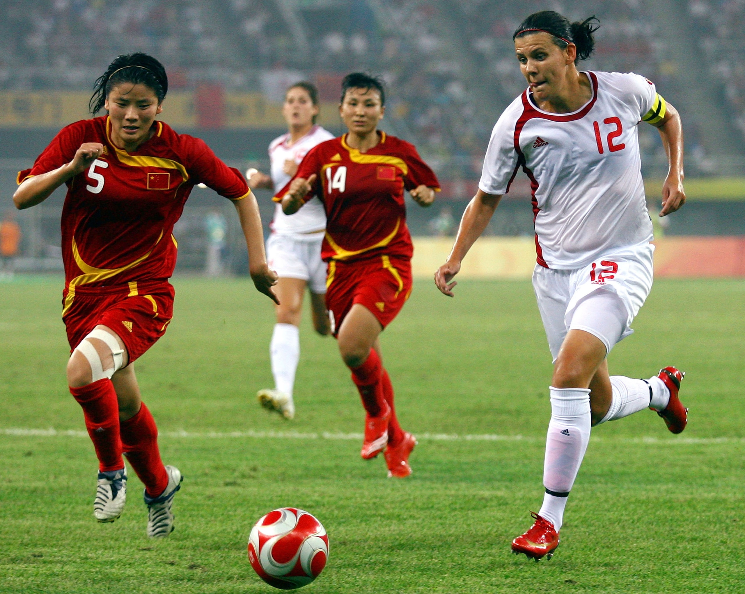 TIANJIN, CHINA - AUGUST 09:  Christine Sinclair (R) of Canada and Xu Yuan of China compete for the ball  during Women's Group E match between Canada and China on Day 1 of the Beijing 2008 Olympic Games on August 9, 2008 in Tianjin, China.  (Photo by Koji