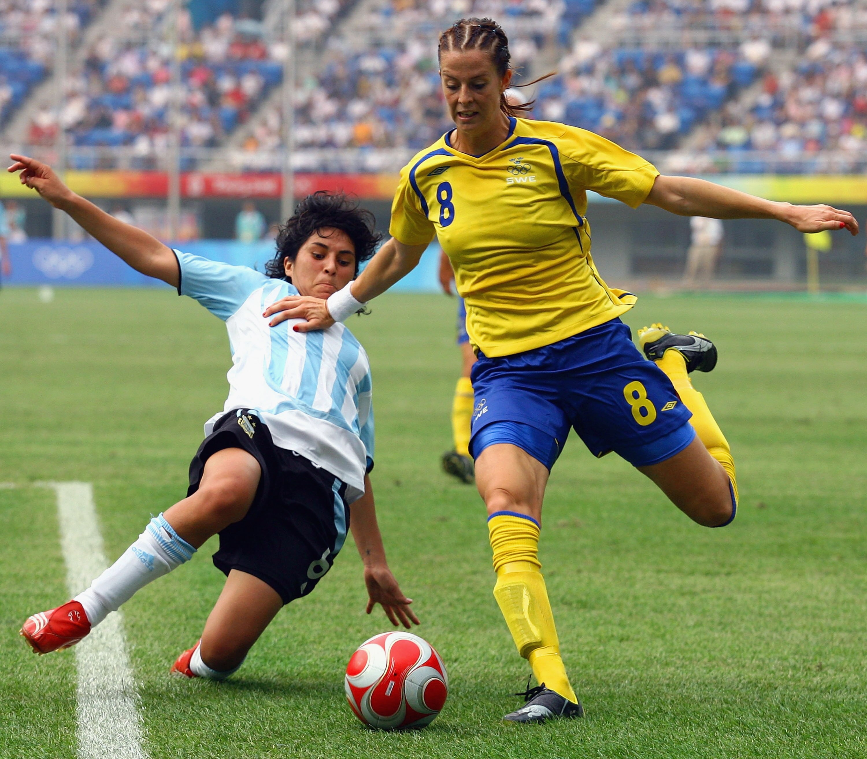 TIANJIN, CHINA - AUGUST 09:  Gabriela Chavez of Argentina challenges Lotta Schelin of Sweden during the Women's Group E match between Sweden and Argentina on Day 1 of the Beijing 2008 Olympic Games on August 9, 2008 in Tianjin, China.  (Photo by Koji Wata