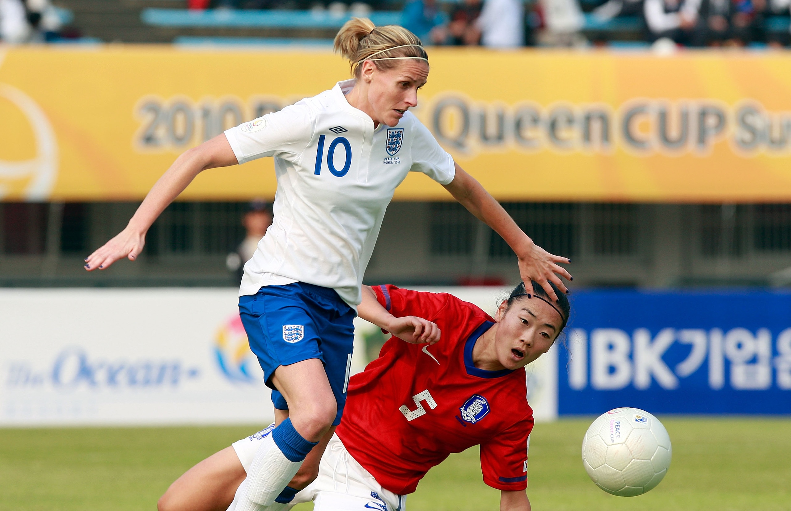 SUWON, SOUTH KOREA - OCTOBER 19:  Kelly Smith of England and Hong Kyung-Suk of South Korea compete for the ball during the Peace Queen Cup match between South Korea and England at Suwon World Cup Stadium on October 19, 2010 in Suwon, South Korea.  (Photo