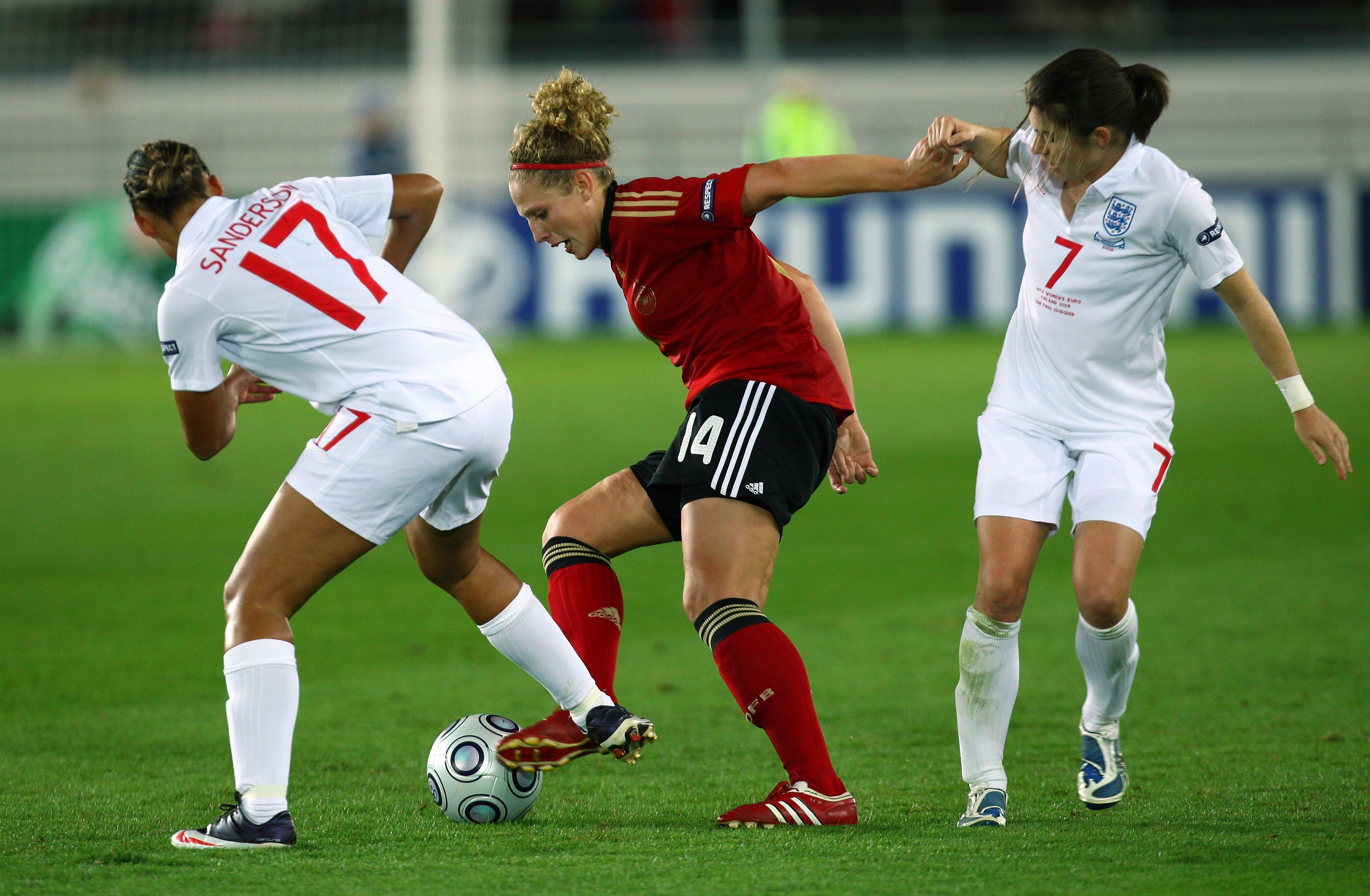HELSINKI, FINLAND - SEPTEMBER 10:  Karen Carney (R) of England tries to tackle Kim Kulig of Germany during the UEFA Women's Euro 2009 Final match between England and Germany at the Helsinki Olympic Stadium on September 10, 2009 in Helsinki, Finland.  (Pho