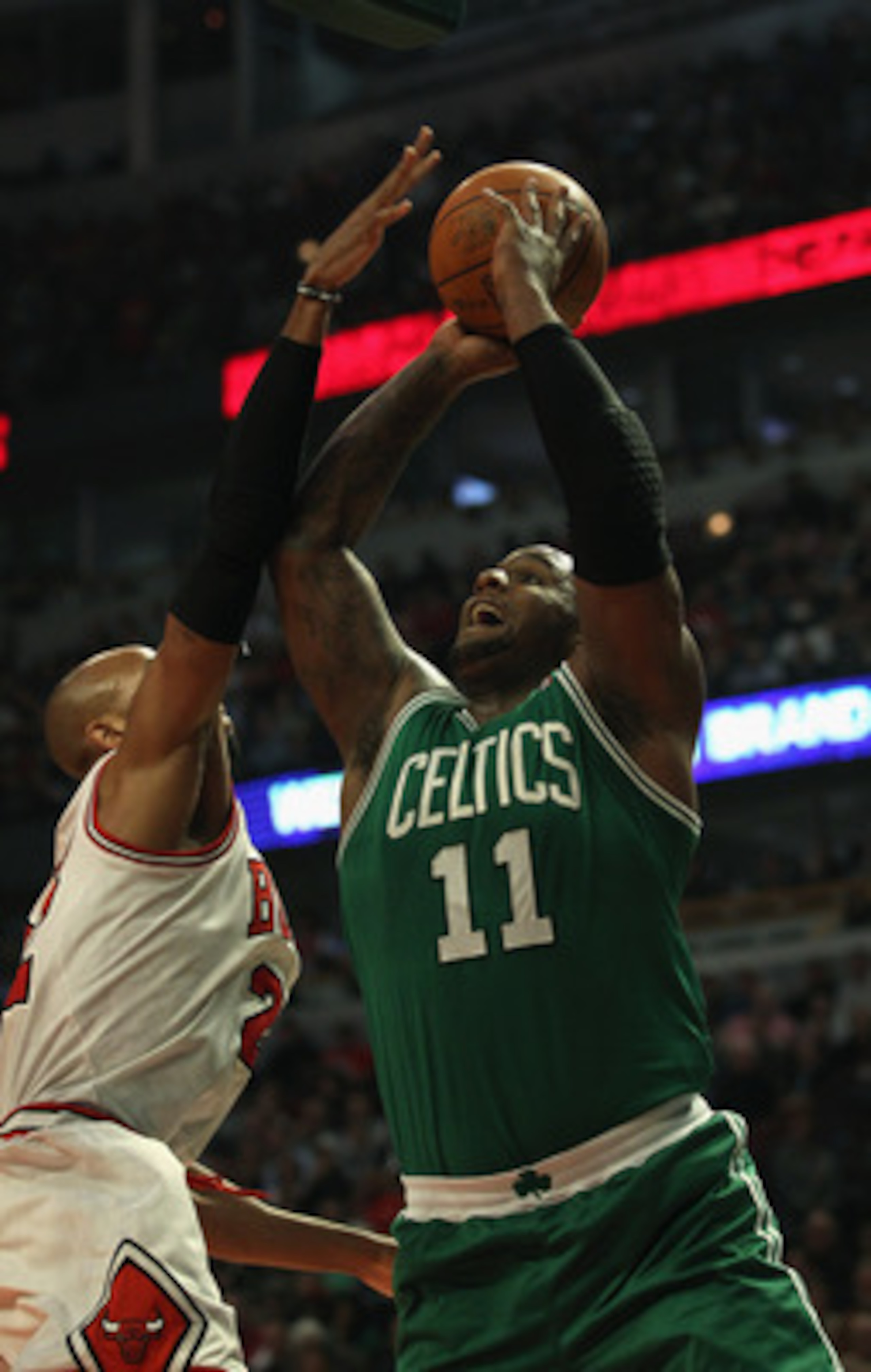 CHICAGO, IL - APRIL 07: Taj Gibson #22 of the Chicago Bulls moves to block a shot by Glen Davis #11 of the Boston Celtics at United Center on April 7, 2011 in Chicago, Illinois. The Bulls defeated the Celtics 97-81. NOTE TO USER: User expressly acknowledg CHICAGO, IL - APRIL 07: Taj Gibson #22 of the Chicago Bulls moves to block a shot by Glen Davis #11 of the Boston Celtics at United Center on April 7, 2011 in Chicago, Illinois. The Bulls defeated the Celtics 97-81. NOTE TO USER: User expressly acknowledg