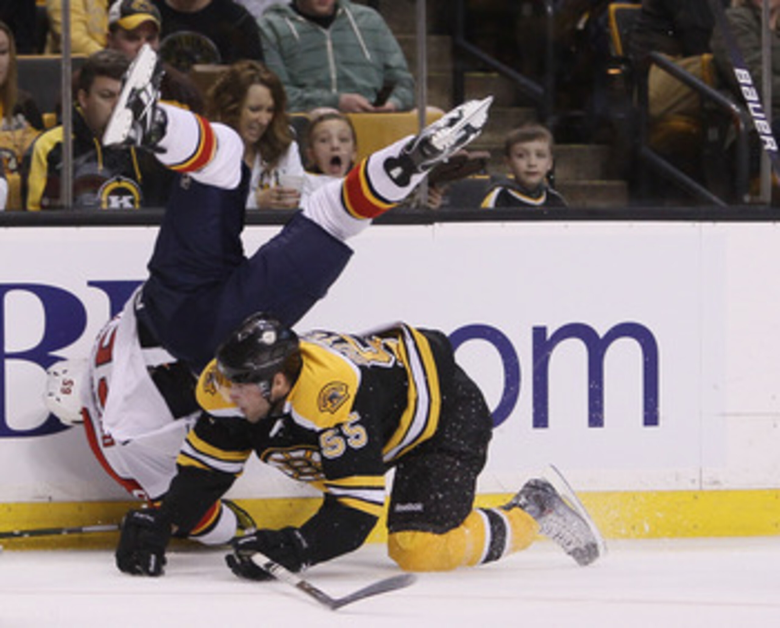 BOSTON - APRIL 01:  Johnny Boychuck #55 of the Boston Bruins checks Victor Oreskovich #65 of the Florida Panthers on April 1, 2010 at the TD Garden in Boston, Massachusetts.  (Photo by Elsa/Getty Images)