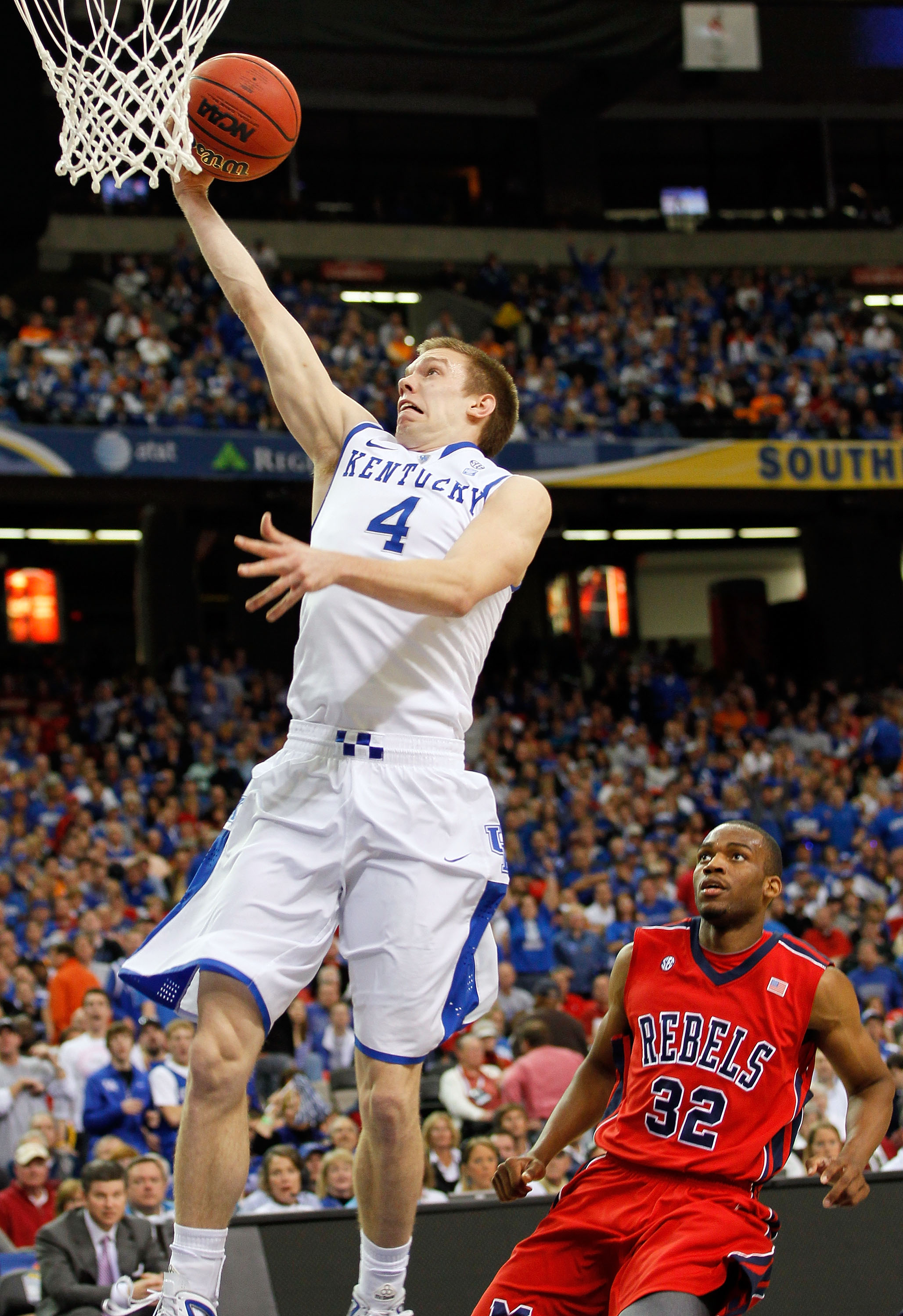 ATLANTA, GA - MARCH 11:  Jon Hood #4 of the Kentucky Wildcats shoots past Zach Graham #32 of the Ole Miss Rebels during the quarterfinals of the SEC Men's Basketball Tournament at Georgia Dome on March 11, 2011 in Atlanta, Georgia.  (Photo by Kevin C. Cox