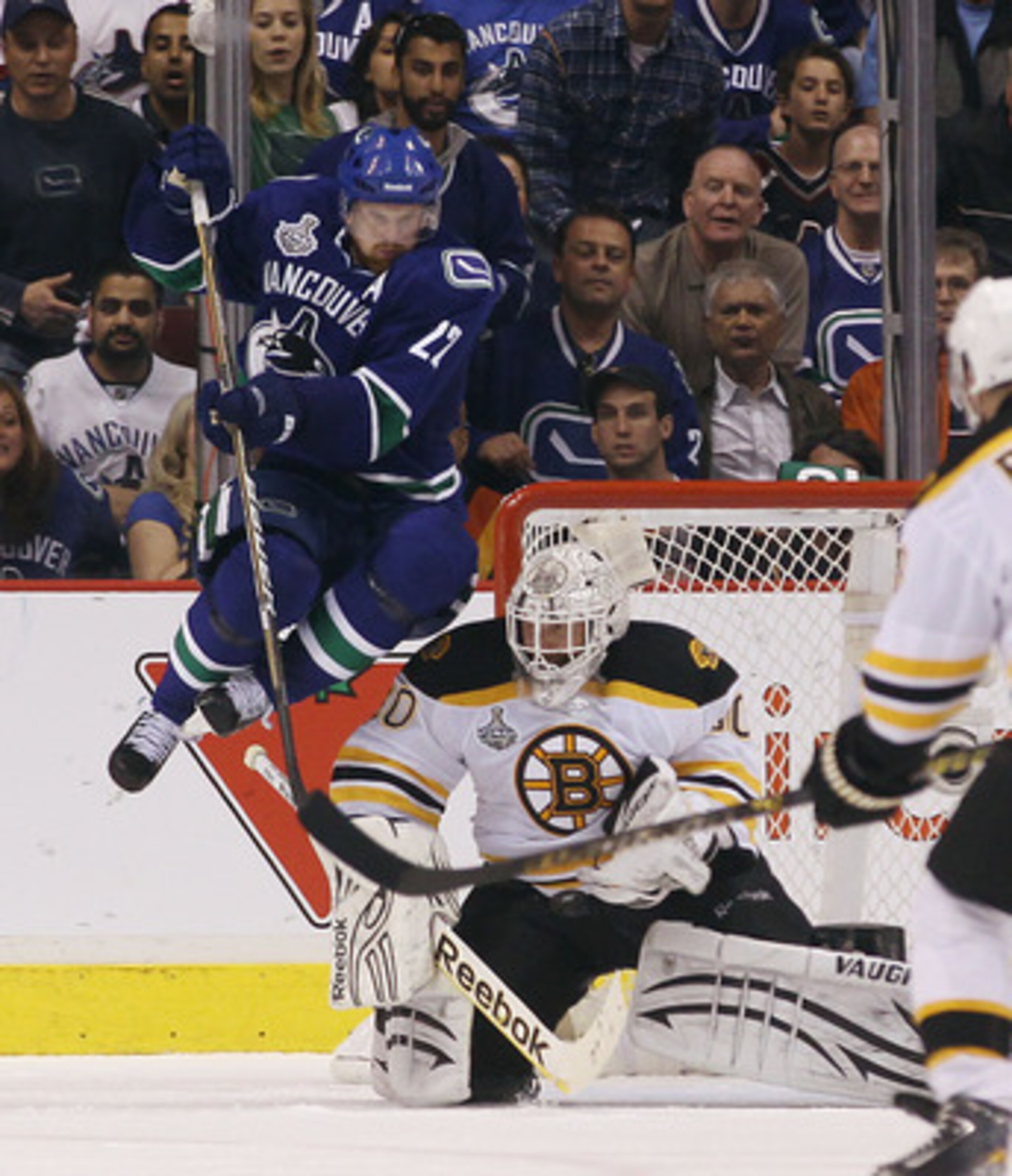 VANCOUVER, BC - JUNE 01:  Tim Thomas #30 of the Boston Bruins makes a save against Daniel Sedin #22 of the Vancouver Canucks during game one of the 2011 NHL Stanley Cup Finals at Rogers Arena on June 1, 2011 in Vancouver, Canada.  (Photo by Bruce Bennett/