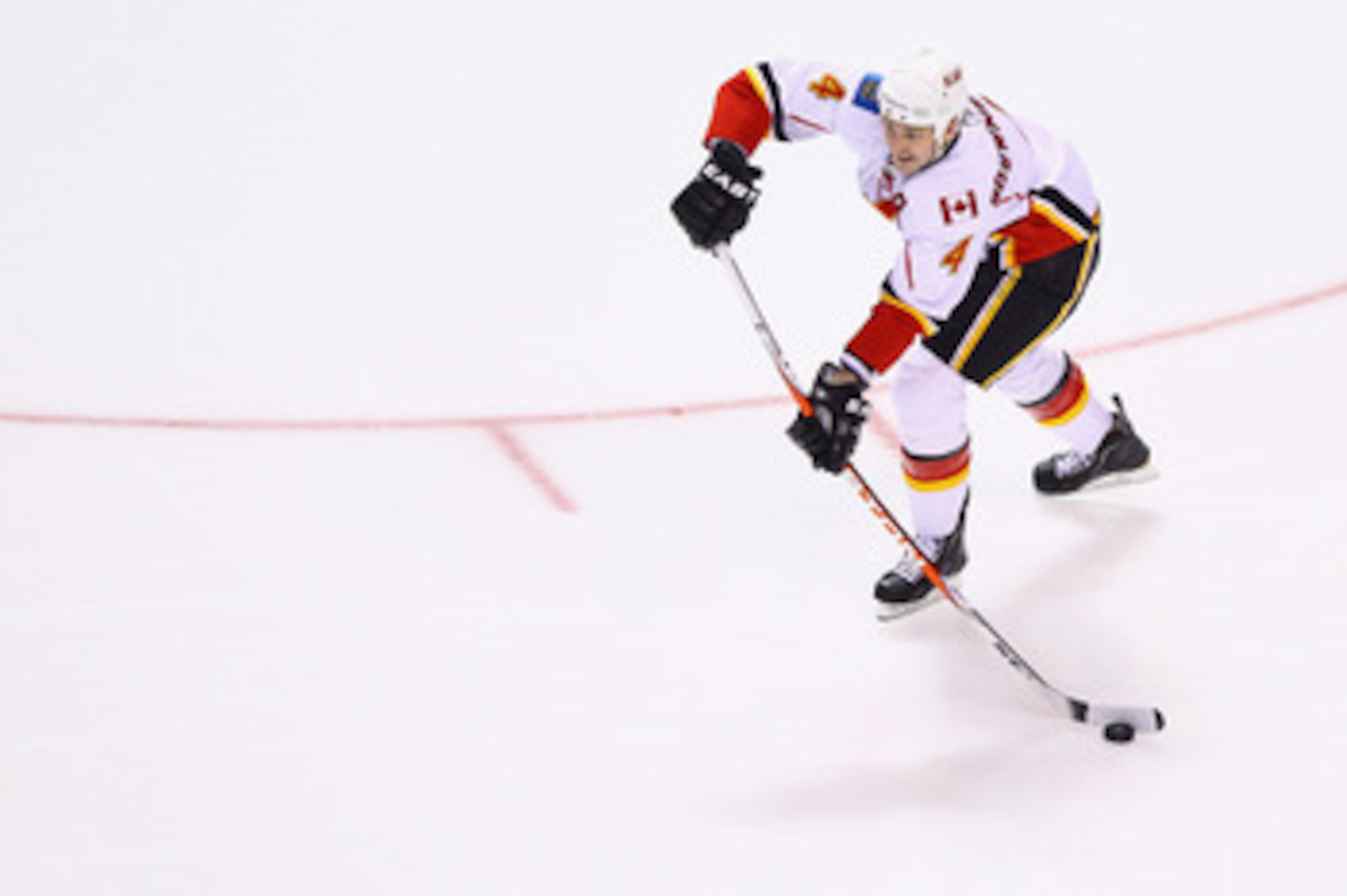 ST. LOUIS, MO - MARCH 1: Jay Bouwmeester #4 of the Calgary Flames passes the puck against the St. Louis Blues at the Scottrade Center on March 1, 2011 in St. Louis, Missouri.  (Photo by Dilip Vishwanat/Getty Images)