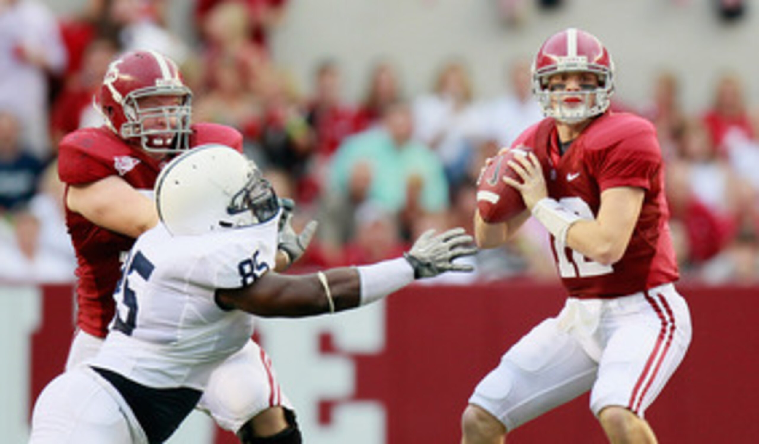 TUSCALOOSA, AL - SEPTEMBER 11:  Quarterback Greg McElroy #12 of the Alabama Crimson Tide looks to pass as Barrett Jones #75 blocks Ollie Ogbu #85 of the Penn State Nittany Lions at Bryant-Denny Stadium on September 11, 2010 in Tuscaloosa, Alabama.  (Photo