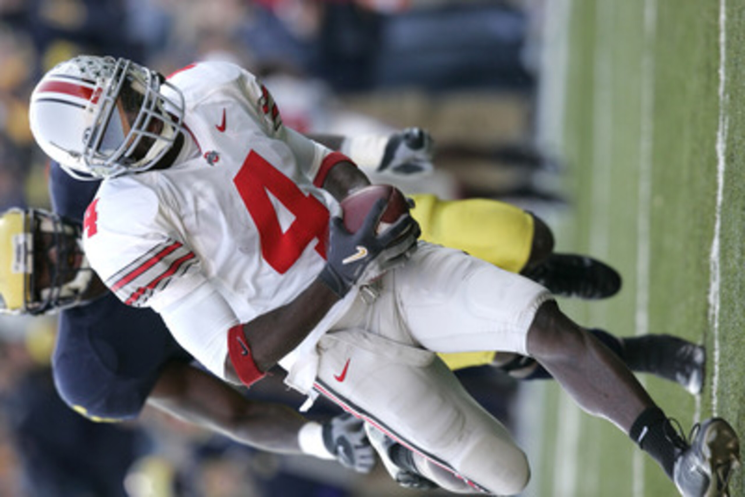ANN ARBOR, MI - NOVEMBER 19: Santonio Holmes #4 of Ohio State runs towards the end zone after a pass reception in the fourth quarter against Michigan on November 19, 2005 at Michigan Stadium in Ann Arbor, Michigan. The Buckeyes defeated the Wolverines 25 ANN ARBOR, MI - NOVEMBER 19: Santonio Holmes #4 of Ohio State runs towards the end zone after a pass reception in the fourth quarter against Michigan on November 19, 2005 at Michigan Stadium in Ann Arbor, Michigan. The Buckeyes defeated the Wolverines 25