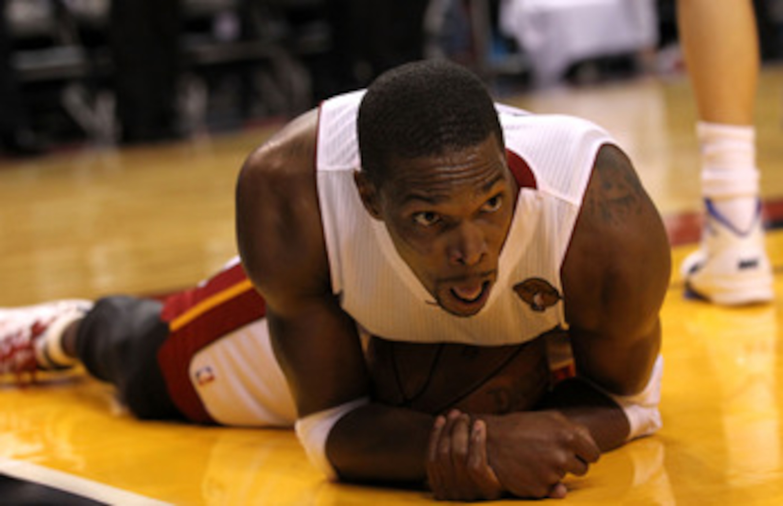 MIAMI, FL - MAY 31:  Chris Bosh #1 of the Miami Heat reacts as he lies on the ball in Game One of the 2011 NBA Finals as the Heat take on the Dallas Mavericks at American Airlines Arena on May 31, 2011 in Miami, Florida. NOTE TO USER: User expressly ackno