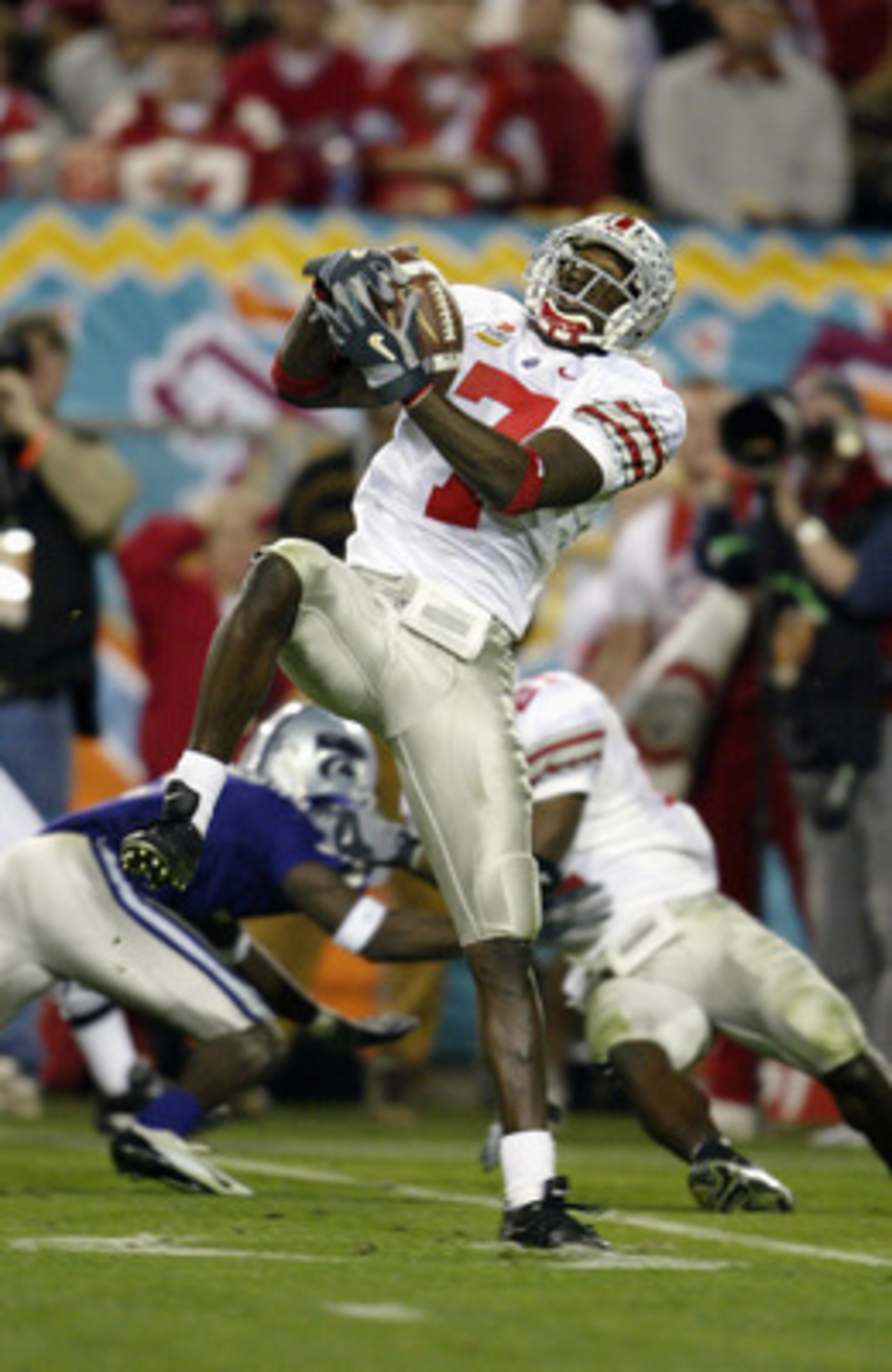 TEMPE, ARIZONA - JANUARY 2: Kick returner Chris Gamble #7 of Ohio State Buckeyes catches a pass during the game against the Kansas State Wildcats in the Tostitos Fiesta Bowl on January 2, 2004 at Sun Devil Stadium in Tempe, Arizona. Gamble announced afte TEMPE, ARIZONA - JANUARY 2: Kick returner Chris Gamble #7 of Ohio State Buckeyes catches a pass during the game against the Kansas State Wildcats in the Tostitos Fiesta Bowl on January 2, 2004 at Sun Devil Stadium in Tempe, Arizona. Gamble announced afte